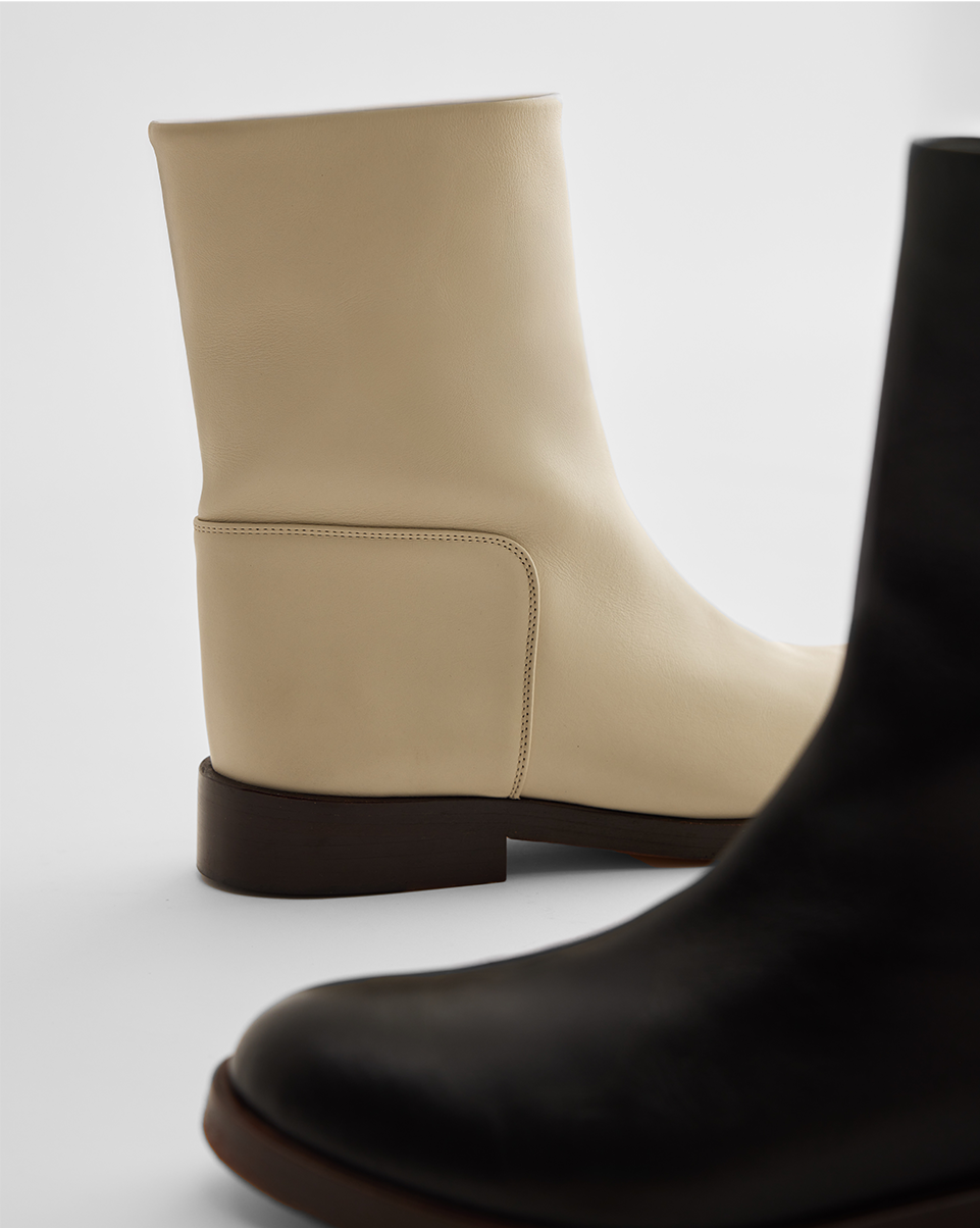 Cream and black smooth leather ankle boots packshot, featuring a square toe and low block heel