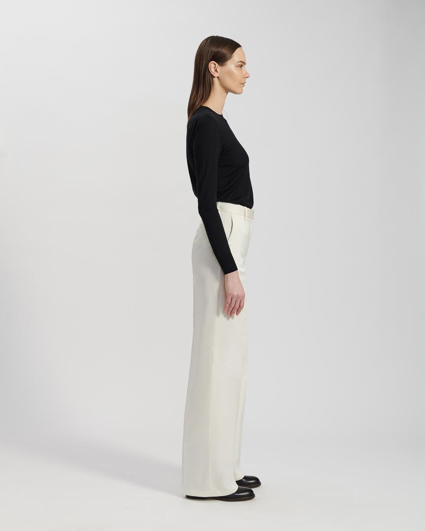 White Anya Trousers in Peau De Soie fabric, stylish bottoms from SALE brand, shown on a model.