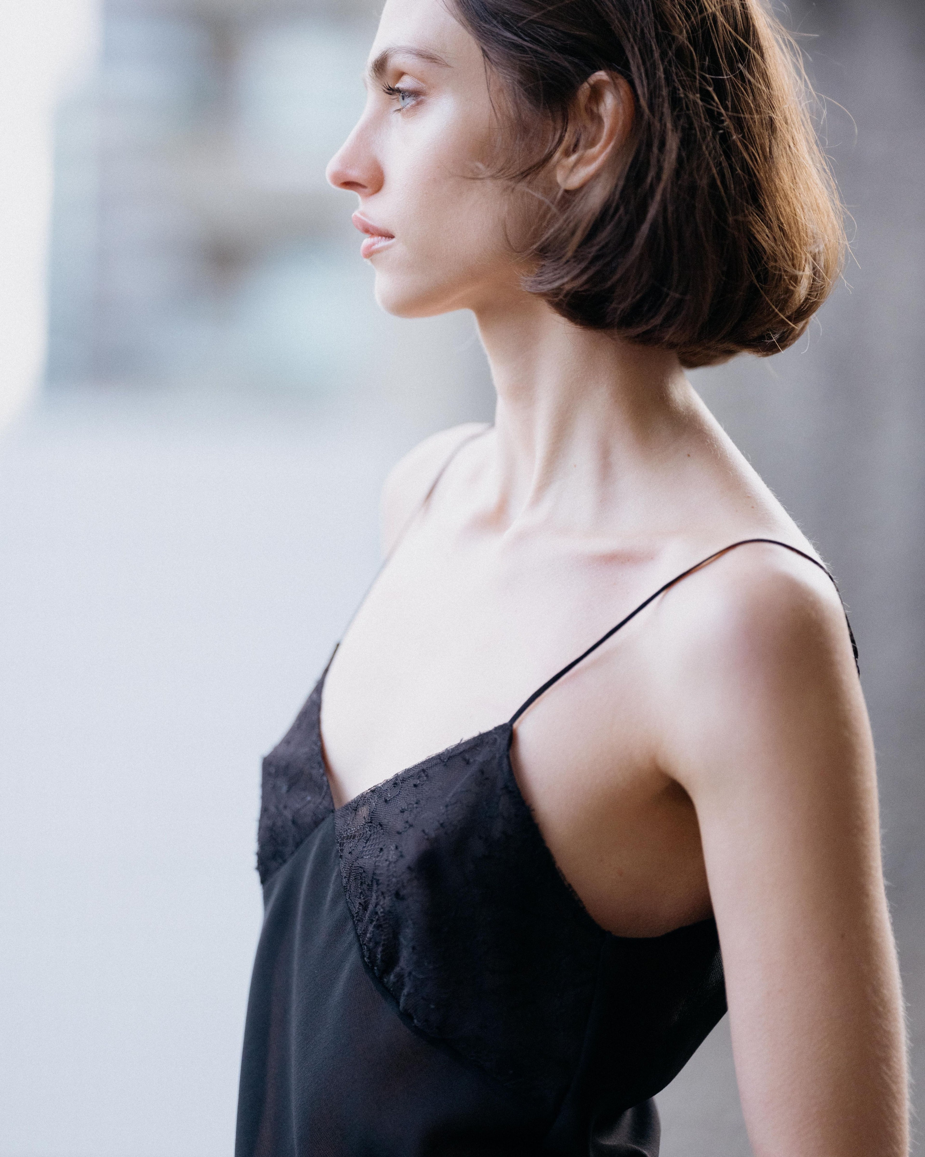 Martina black wool & lace camisole top on model, semi-sheer with Chantilly lace V-neck & spaghetti straps