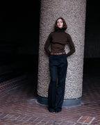 Olive green Evanne silk crepe turtleneck knitwear by Veronica De Piante, close-up of the textured fabric and high neckline.