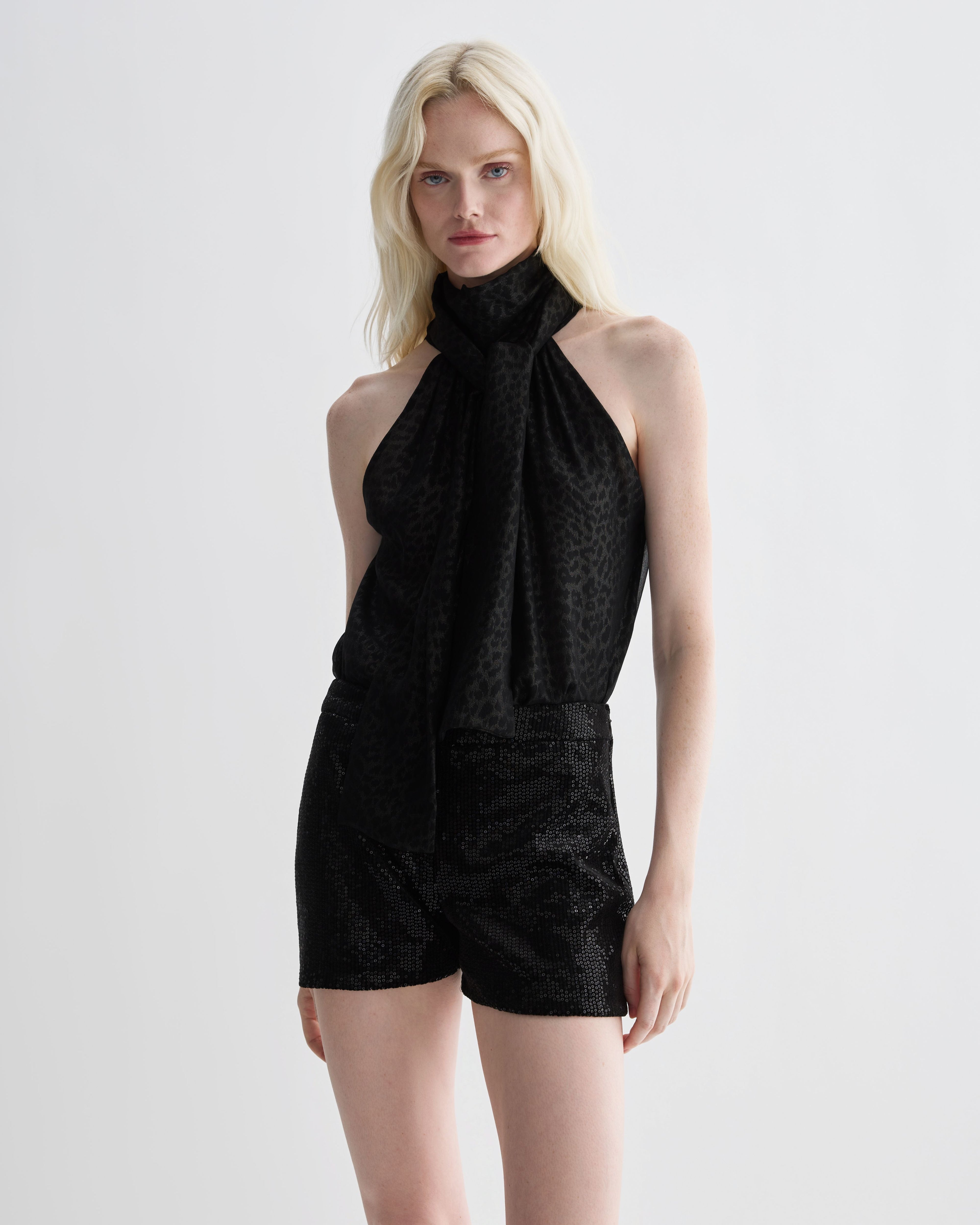 Black Helena Shorts in stretch sequin by Veronica De Piante, featuring a fitted design and shimmering sequin fabric.