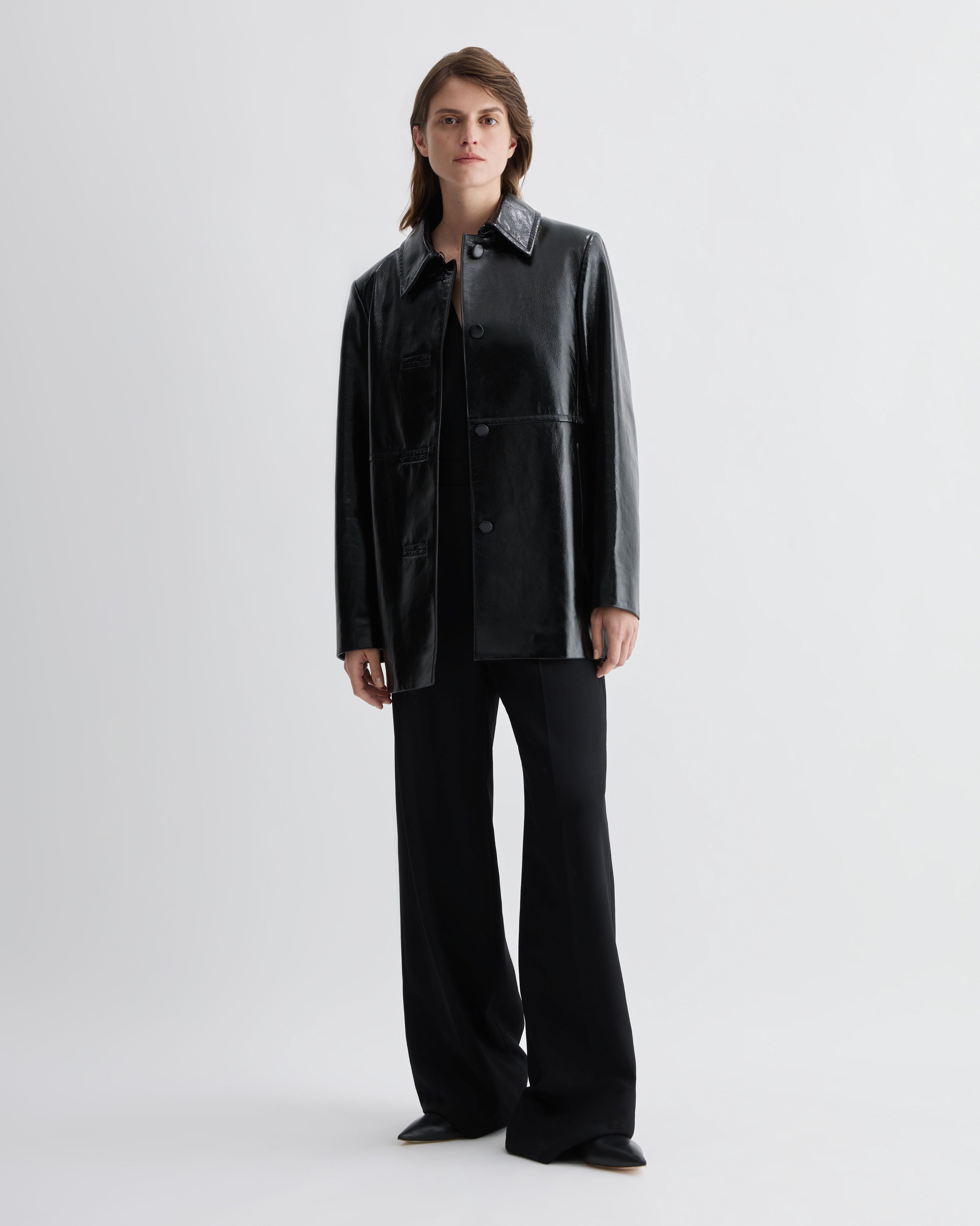 Black Jess jacket in patent leather by Veronica De Piante, stylish coat featuring glossy finish and tailored fit.