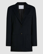 Black Sebastian jacket in stretch wool twill by Veronica De Piante, shown on a mannequin, featuring a tailored fit and classic design.