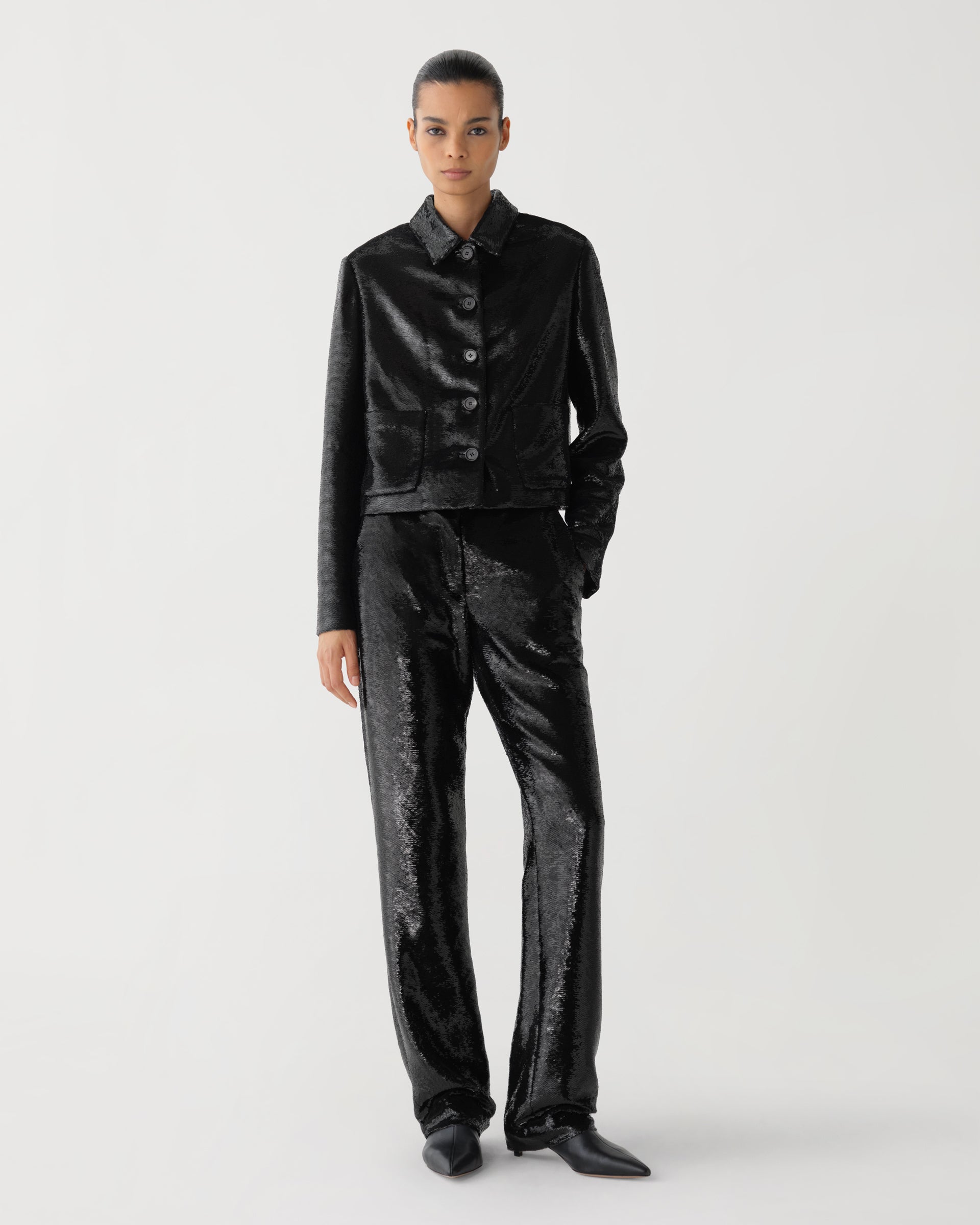 Black Ines jacket in flat sequin by Veronica De Piante, showcasing the shiny, textured sequin details on a stylish coat.