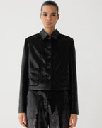 Black Ines Jacket in flat sequins by Veronica De Piante, shown on a hanger with close-up of its shimmering sequin details.