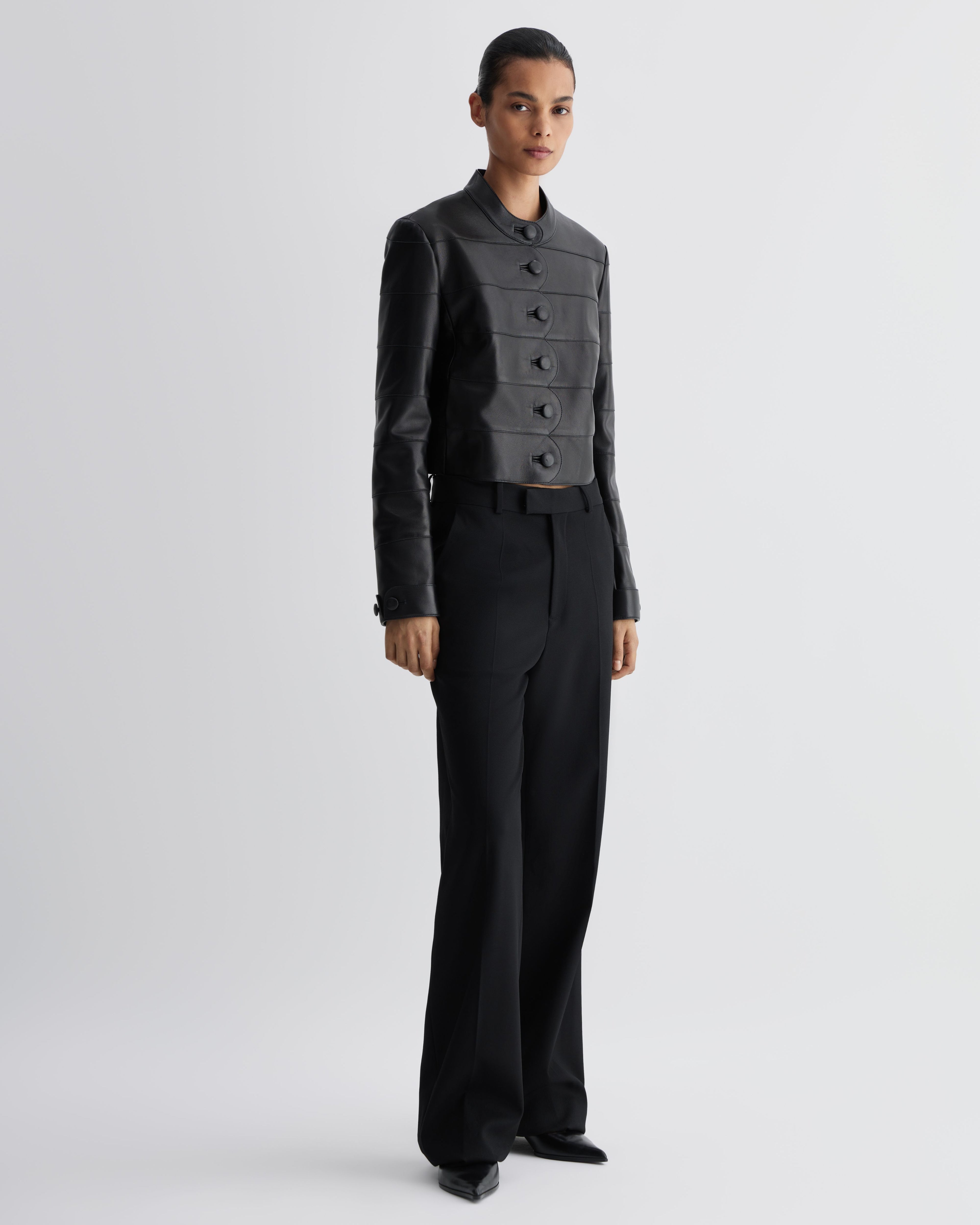 Black Rory jacket in Nappa leather by Veronica De Piante, featuring a sleek, fitted coat with detailed stitching and classic collar.