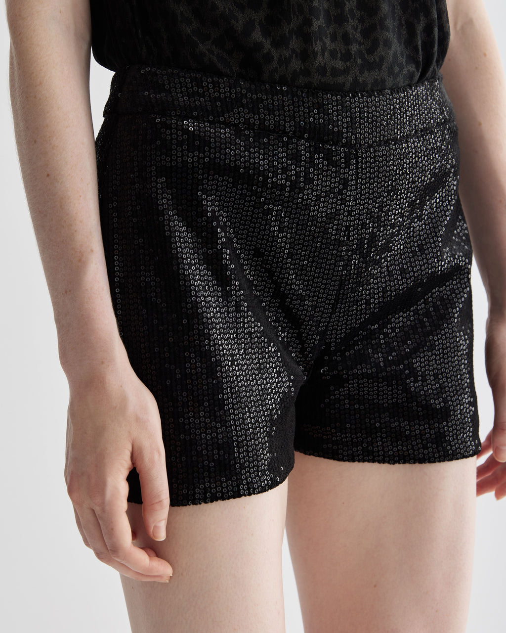 Black Helena Shorts in stretch sequin by Veronica De Piante, featuring a fitted design and shimmering sequin fabric.