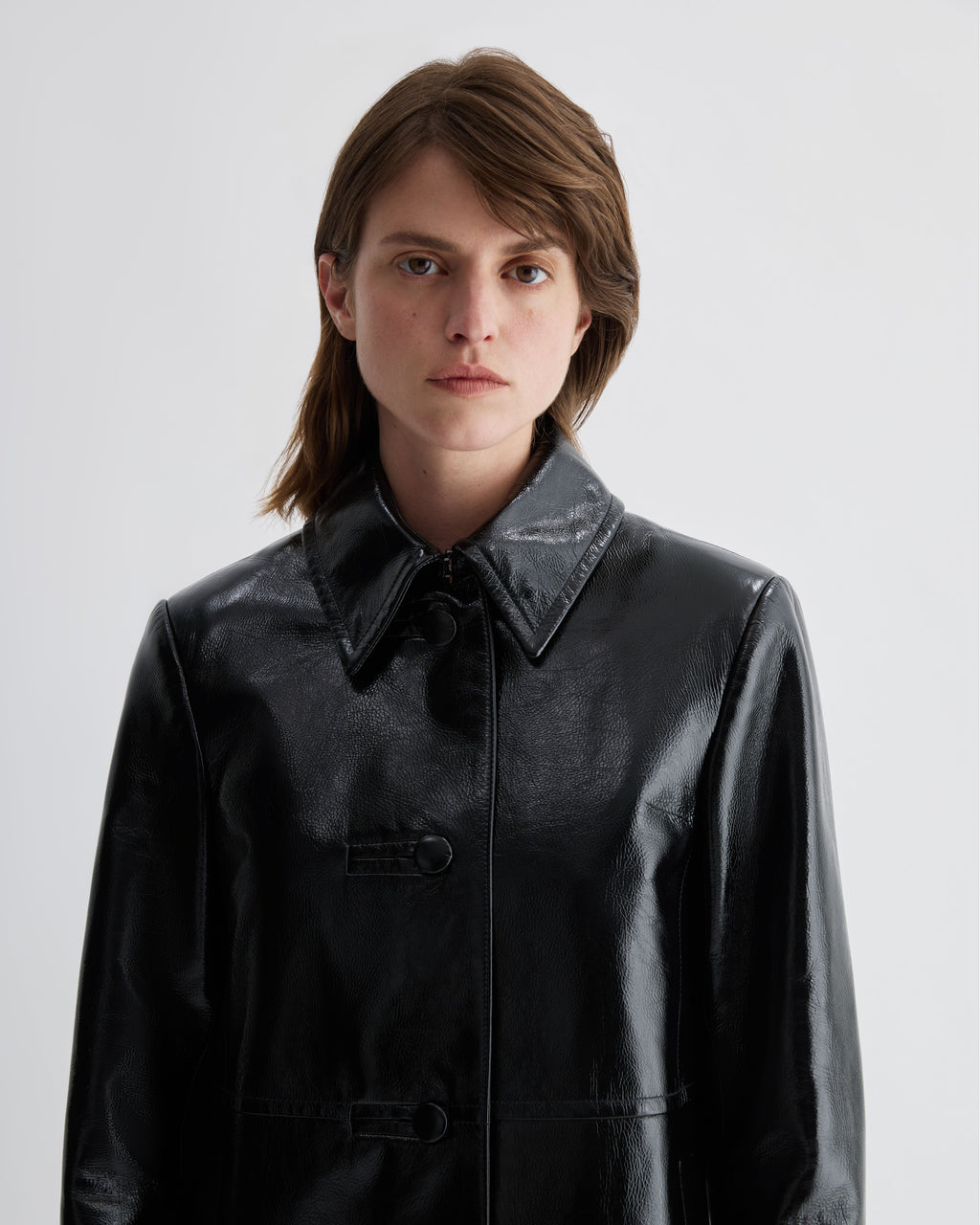 Black patent leather Jess jacket by Veronica De Piante, stylish coat with a shiny, smooth finish and tailored fit.