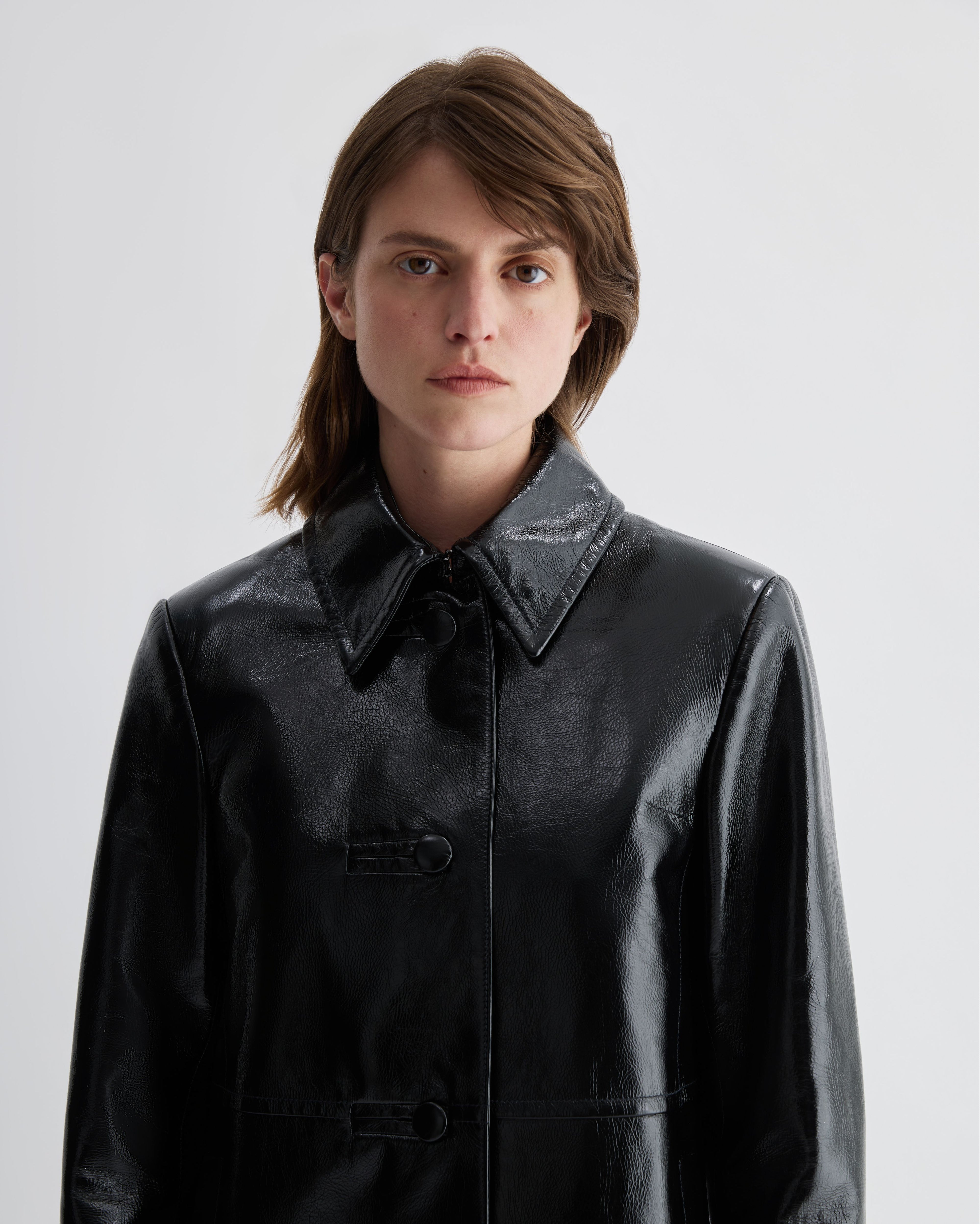 Black patent leather Jess jacket by Veronica De Piante, stylish coat with a shiny, smooth finish and tailored fit.