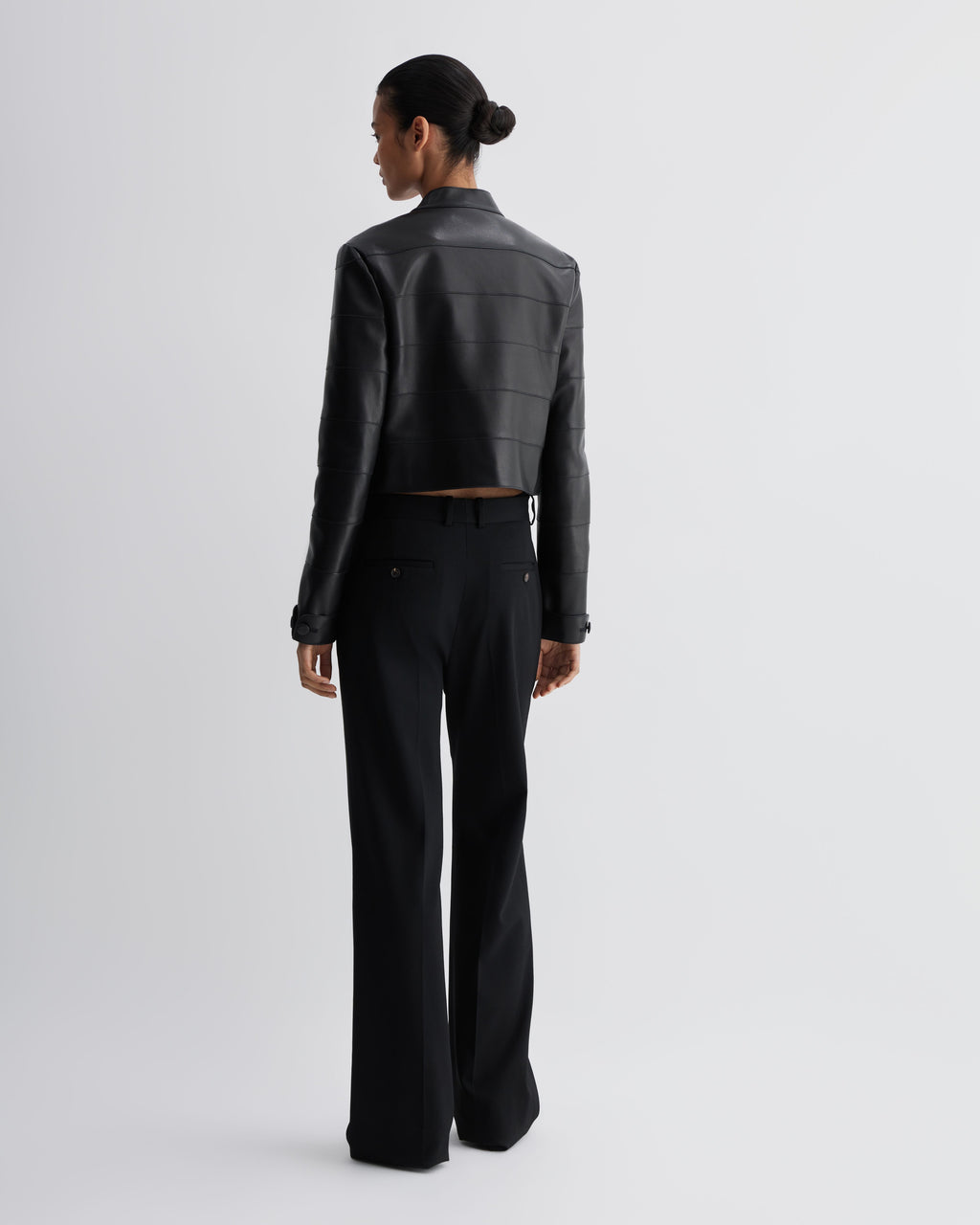 Veronica De Piante Rory black nappa leather jacket with a sleek, tailored fit, shown hanging on a hanger.