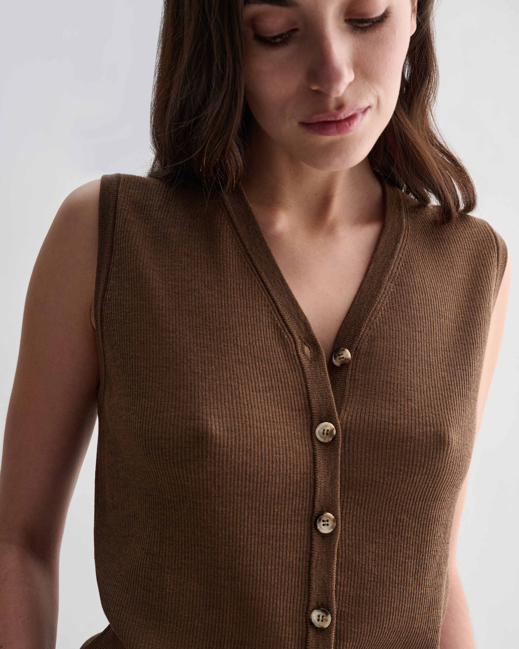 Alice Vest in Camel Merino Wool, fine ribbed knit, V-neck, sleeveless, front buttons. Luxury women's knitwear