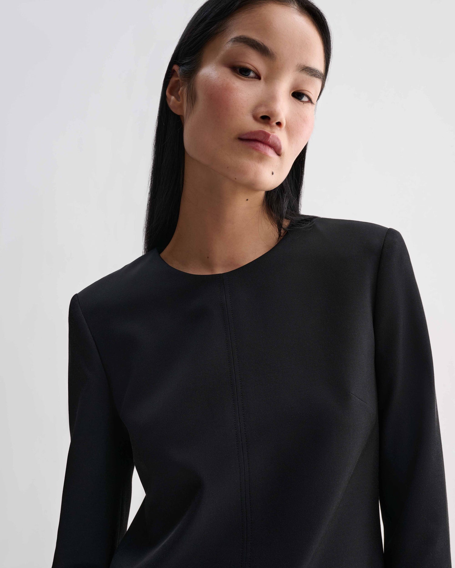 Black silk Ambar tunic top by Veronica De Piante featuring a relaxed fit and elegant drape on a model.