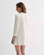 Off-white silk Ambar Tunic by Veronica De Piante, displayed on a hanger with its flowing, elegant fabric and minimalist design.