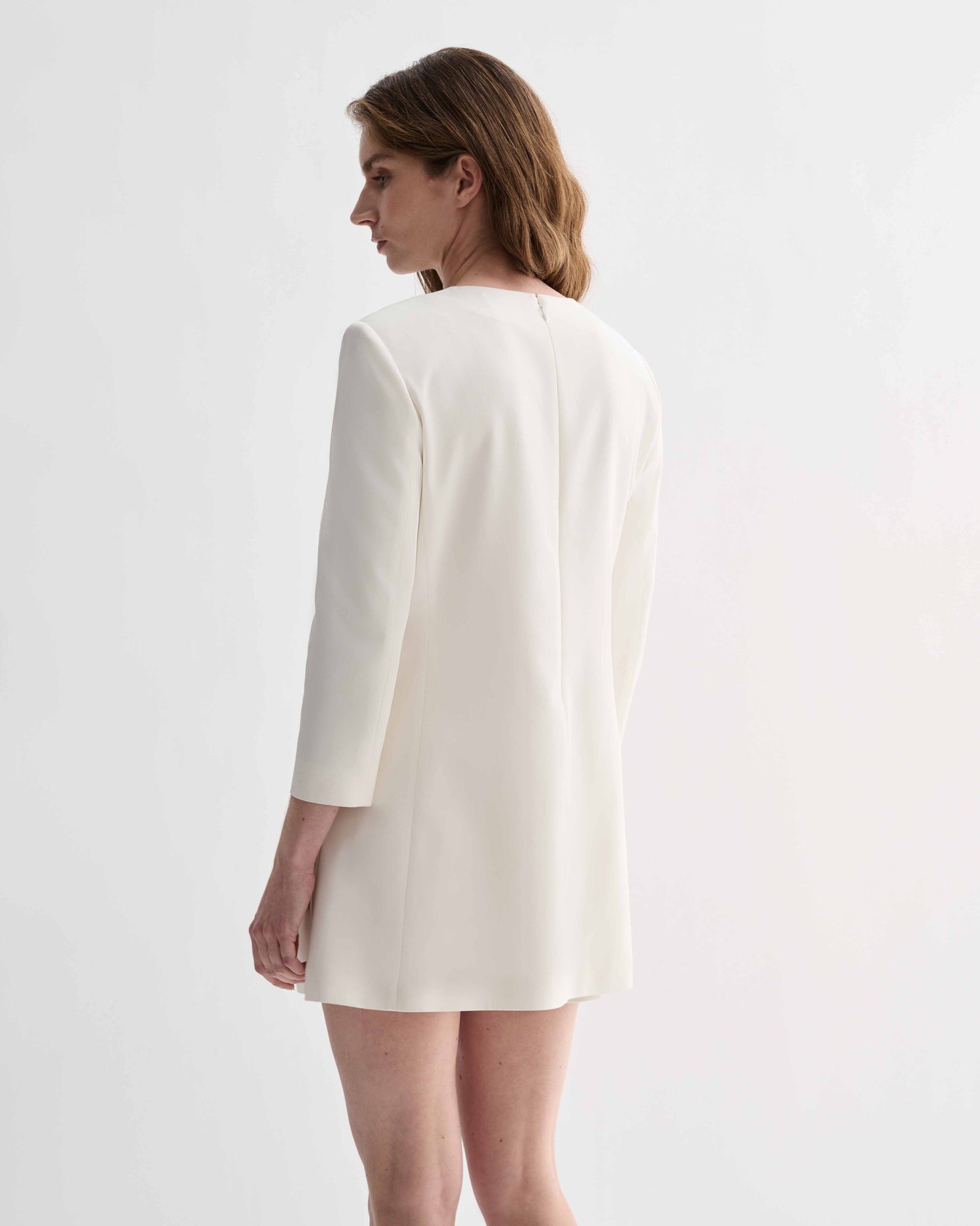 Off-white silk Ambar Tunic by Veronica De Piante, displayed on a hanger with its flowing, elegant fabric and minimalist design.