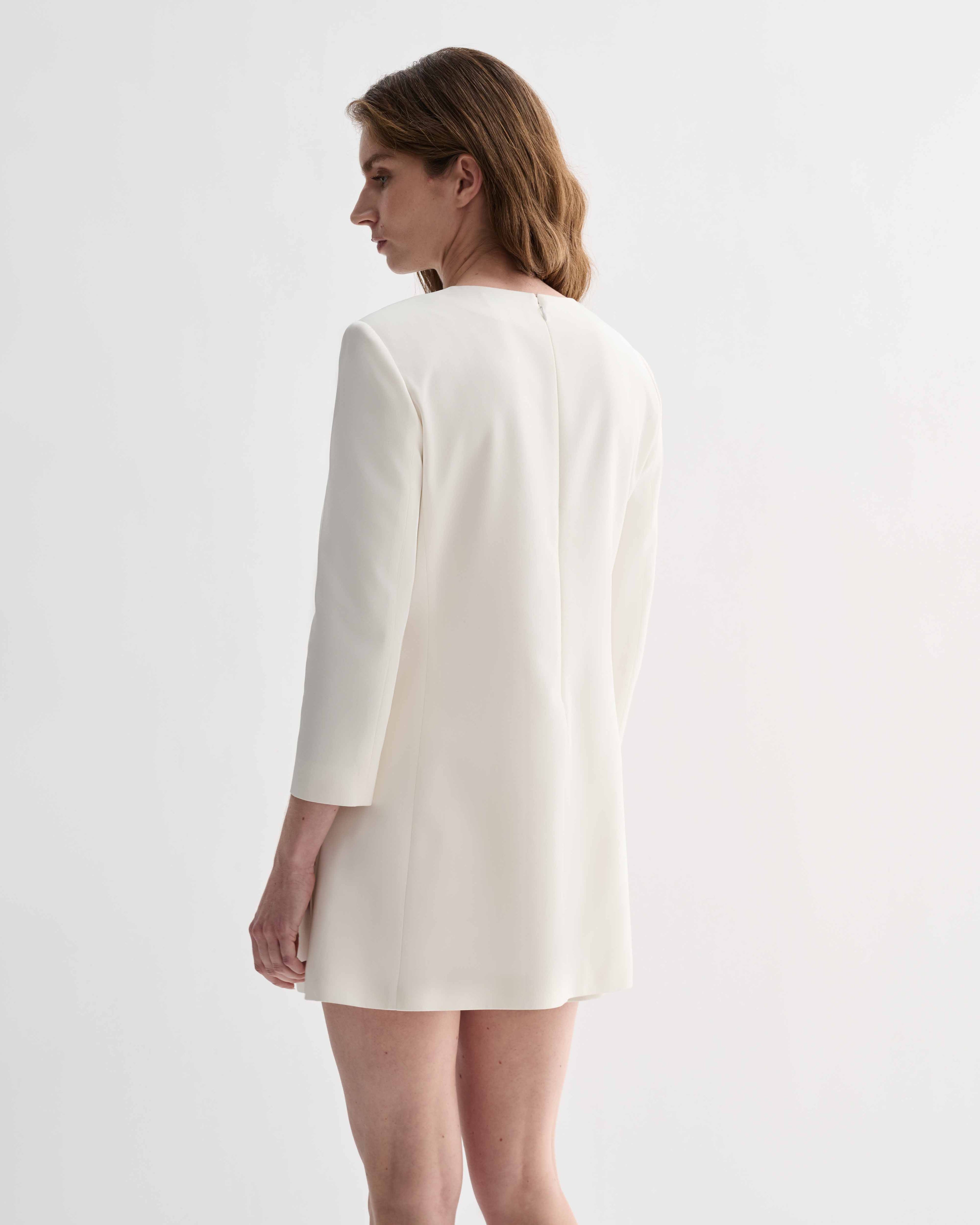Off-white silk Ambar Tunic by Veronica De Piante, displayed on a hanger with its flowing, elegant fabric and minimalist design.