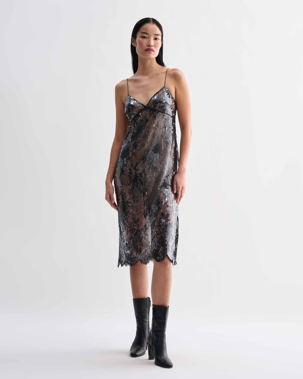 Black Veronica De Piante Aya lace sequin dress displayed on a hanger with intricate lace and sequin details.