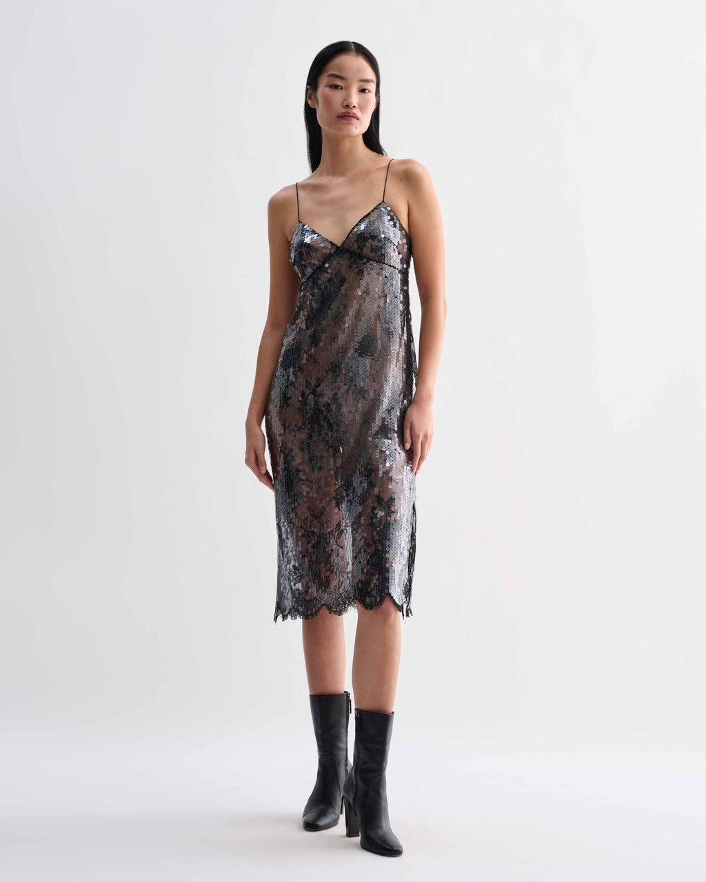 Black Veronica De Piante Aya lace sequin dress displayed on a hanger with intricate lace and sequin details.