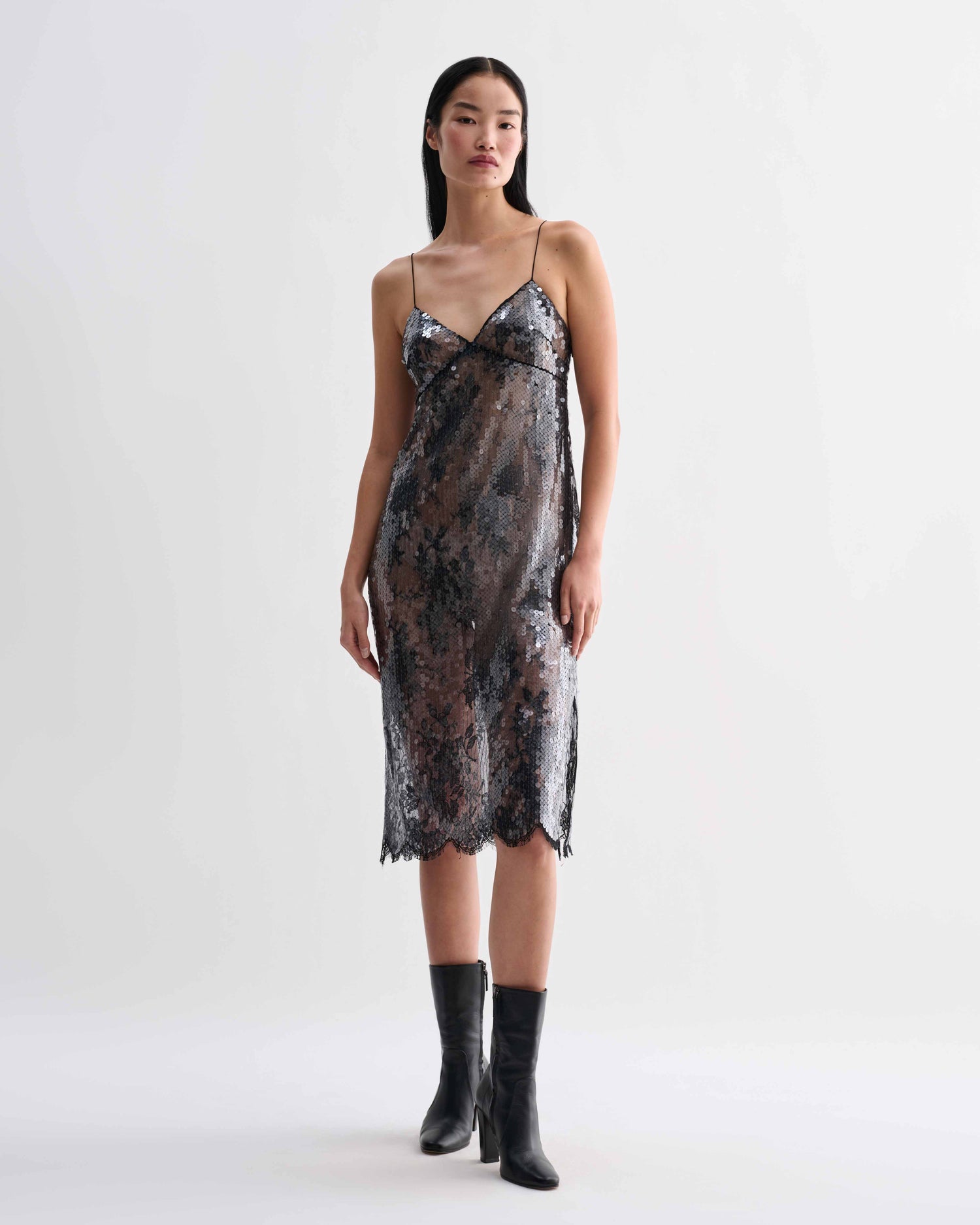 Black Veronica De Piante Aya lace sequin dress displayed on a hanger with intricate lace and sequin details.