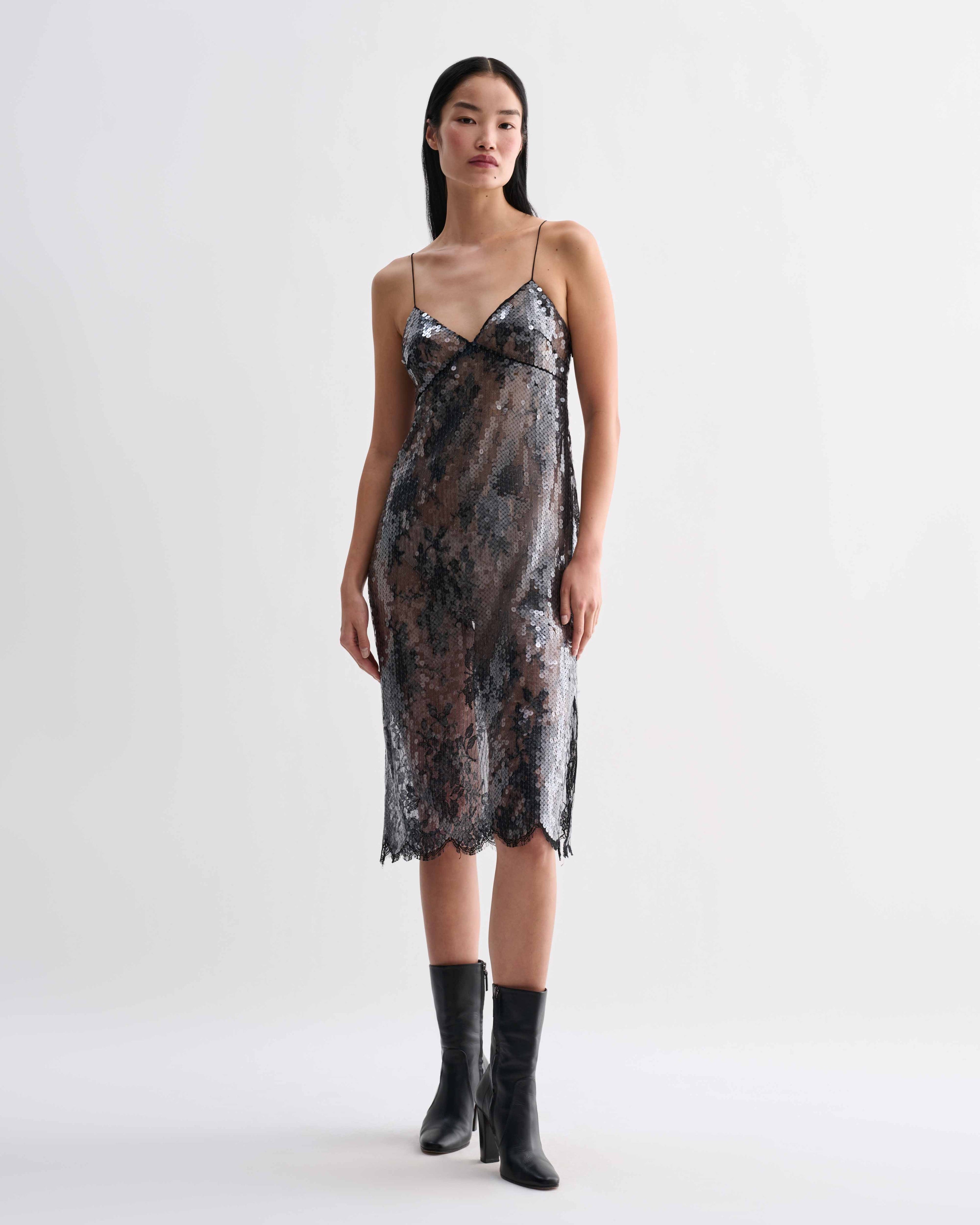 Black Veronica De Piante Aya lace sequin dress displayed on a hanger with intricate lace and sequin details.