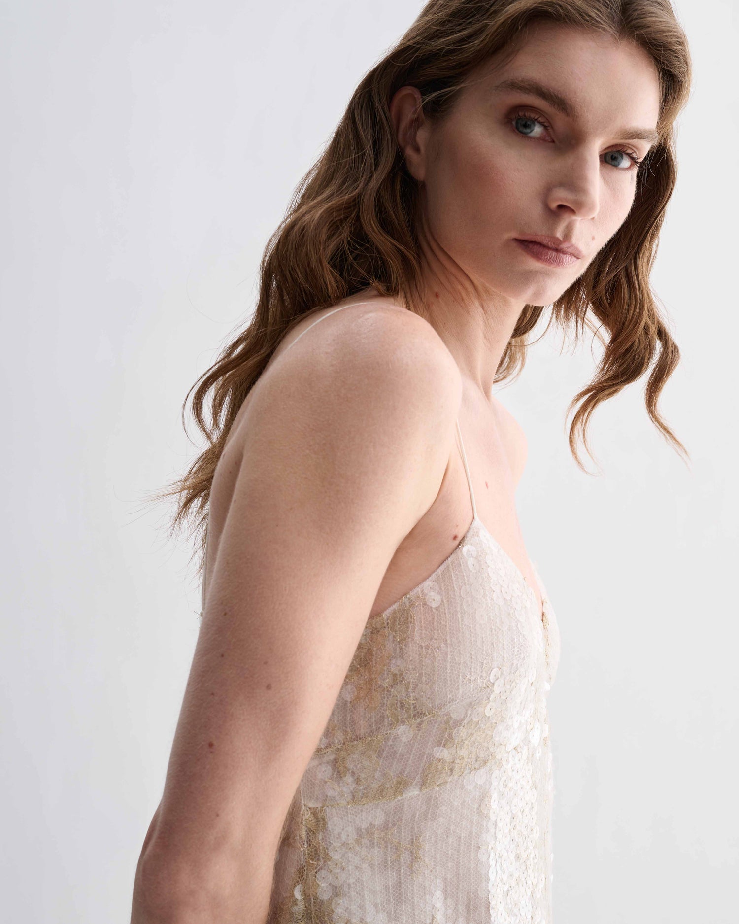 Veronica De Piante Aya gold lace sequin dress with elegant design, showcasing intricate lace and shimmering sequins.