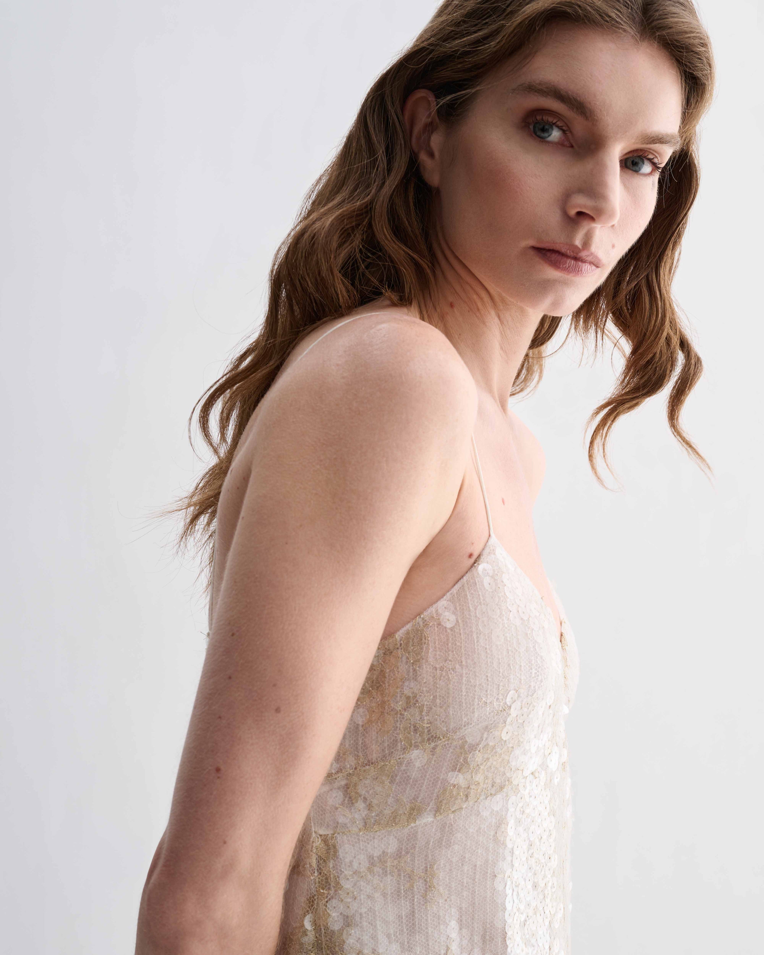 Veronica De Piante Aya gold lace sequin dress with elegant design, showcasing intricate lace and shimmering sequins.
