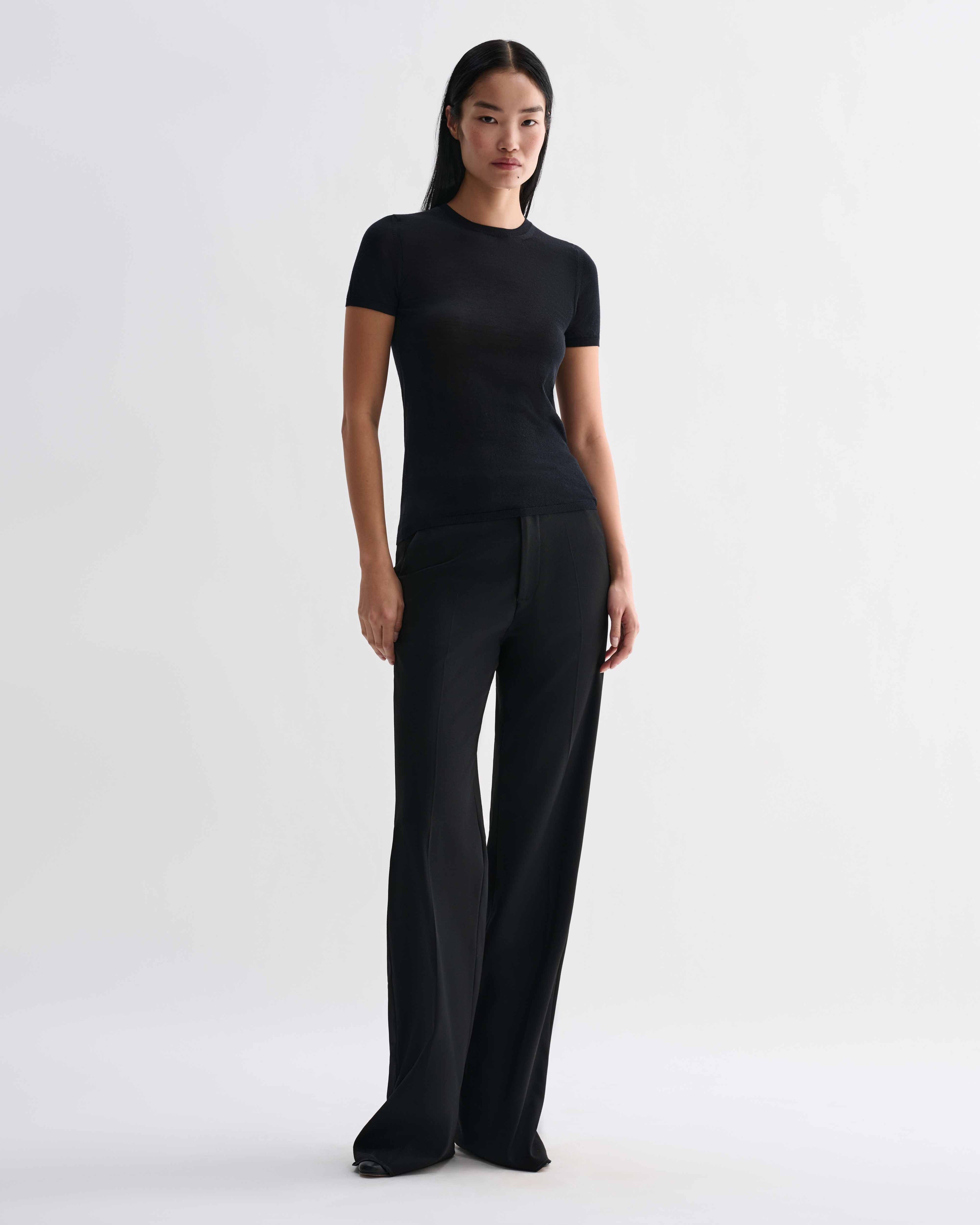 Black Bea Knit Top made from superfine merino wool by Veronica De Piante, shown on a model with a close-up of the fabric texture.