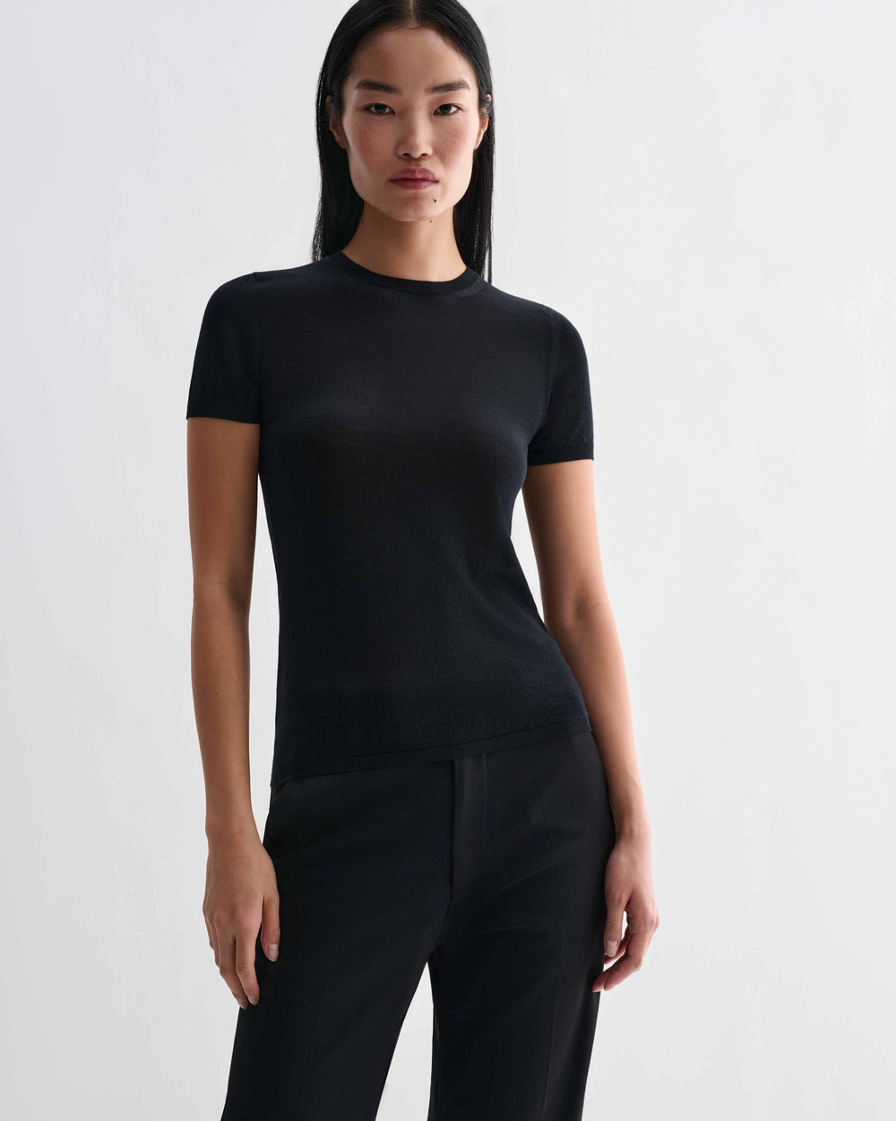 Veronica De Piante Bea Knit Top in black, made from superfine merino wool, showcasing a close-up of the soft, fitted knit fabric.