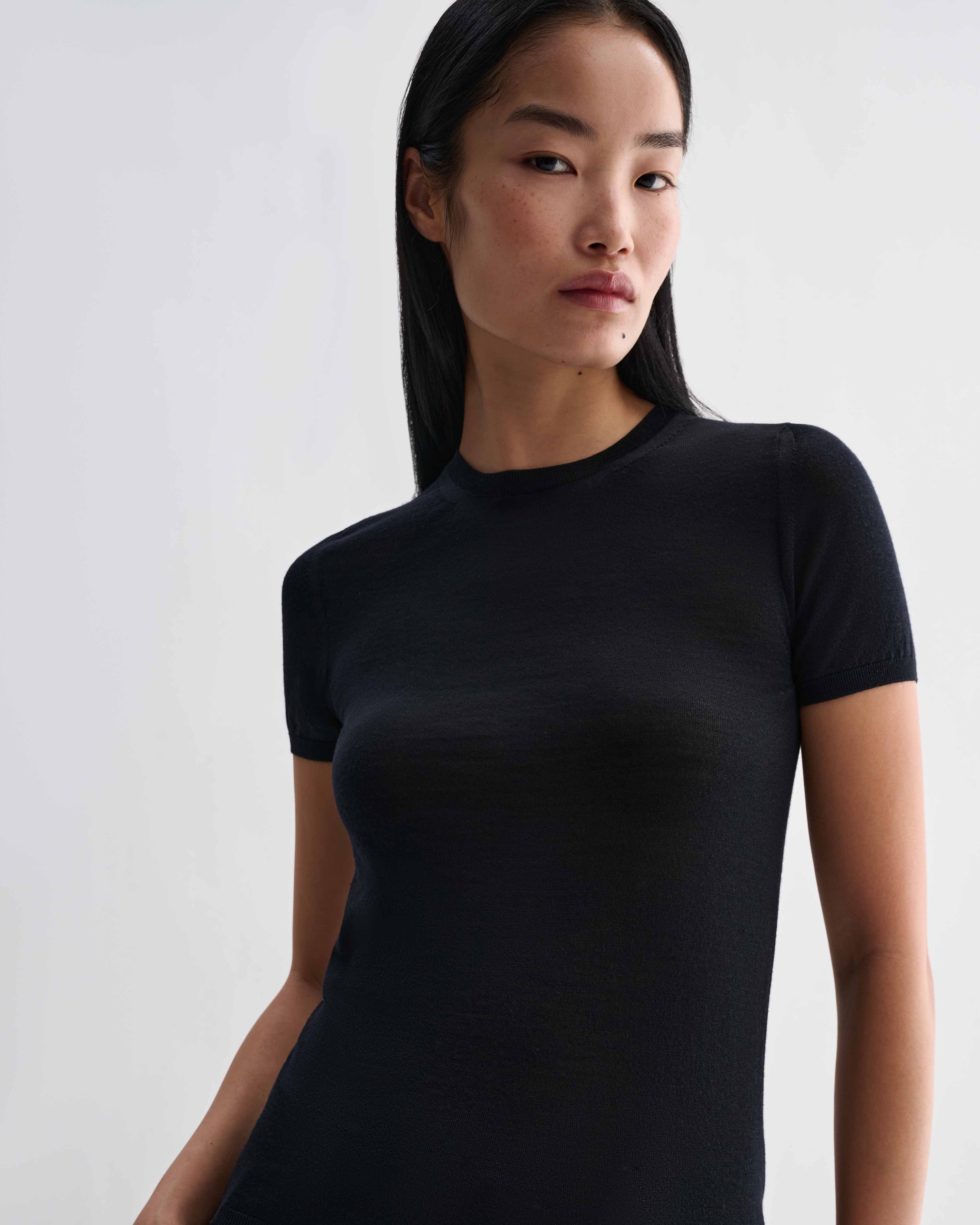 Black Bea Knit Top in superfine Merino wool by Veronica De Piante, featuring a close-up of the textured knit fabric.