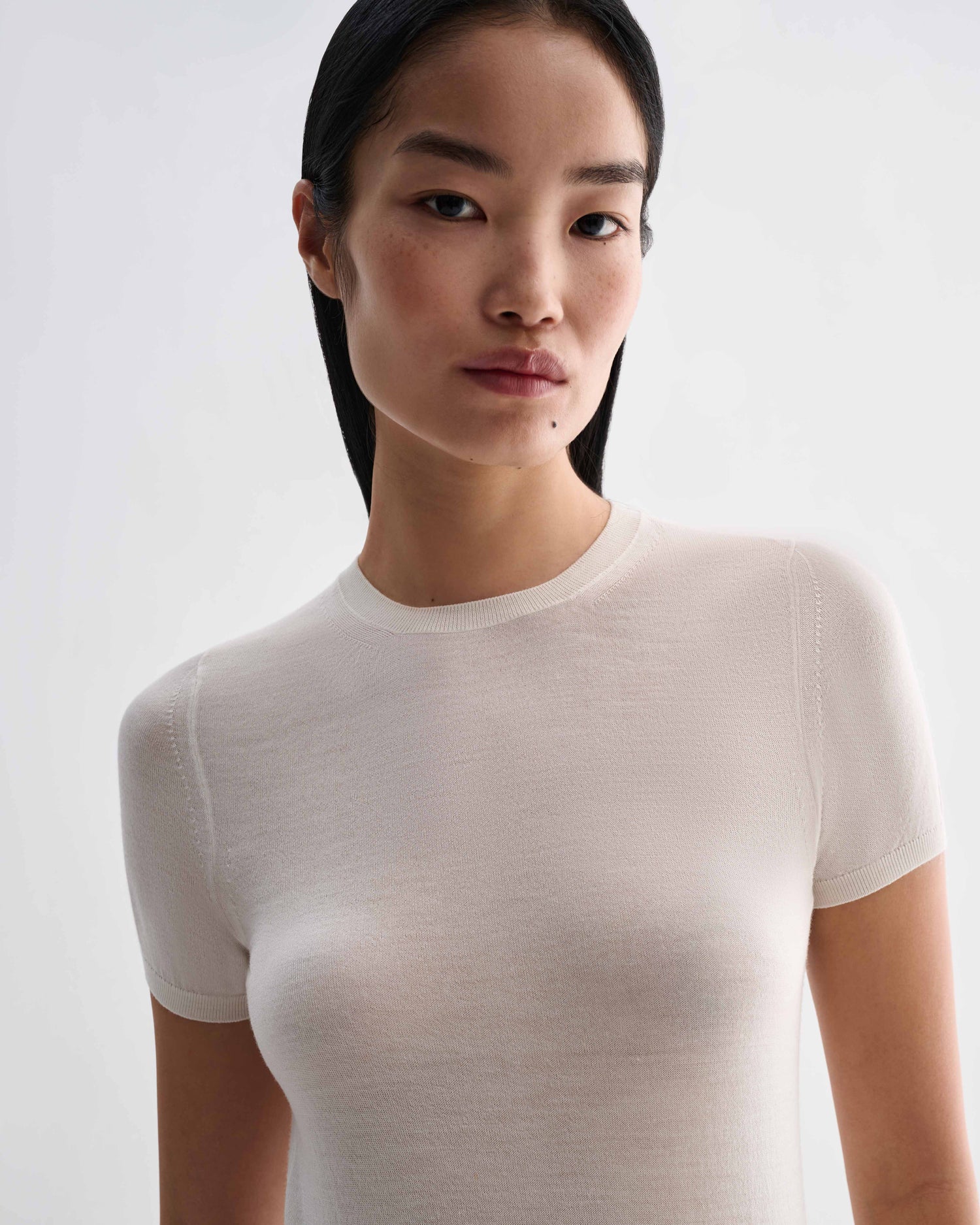 Veronica De Piante Bea Knit Top in off-white superfine merino wool, close-up showing soft fabric and simple crew neckline.