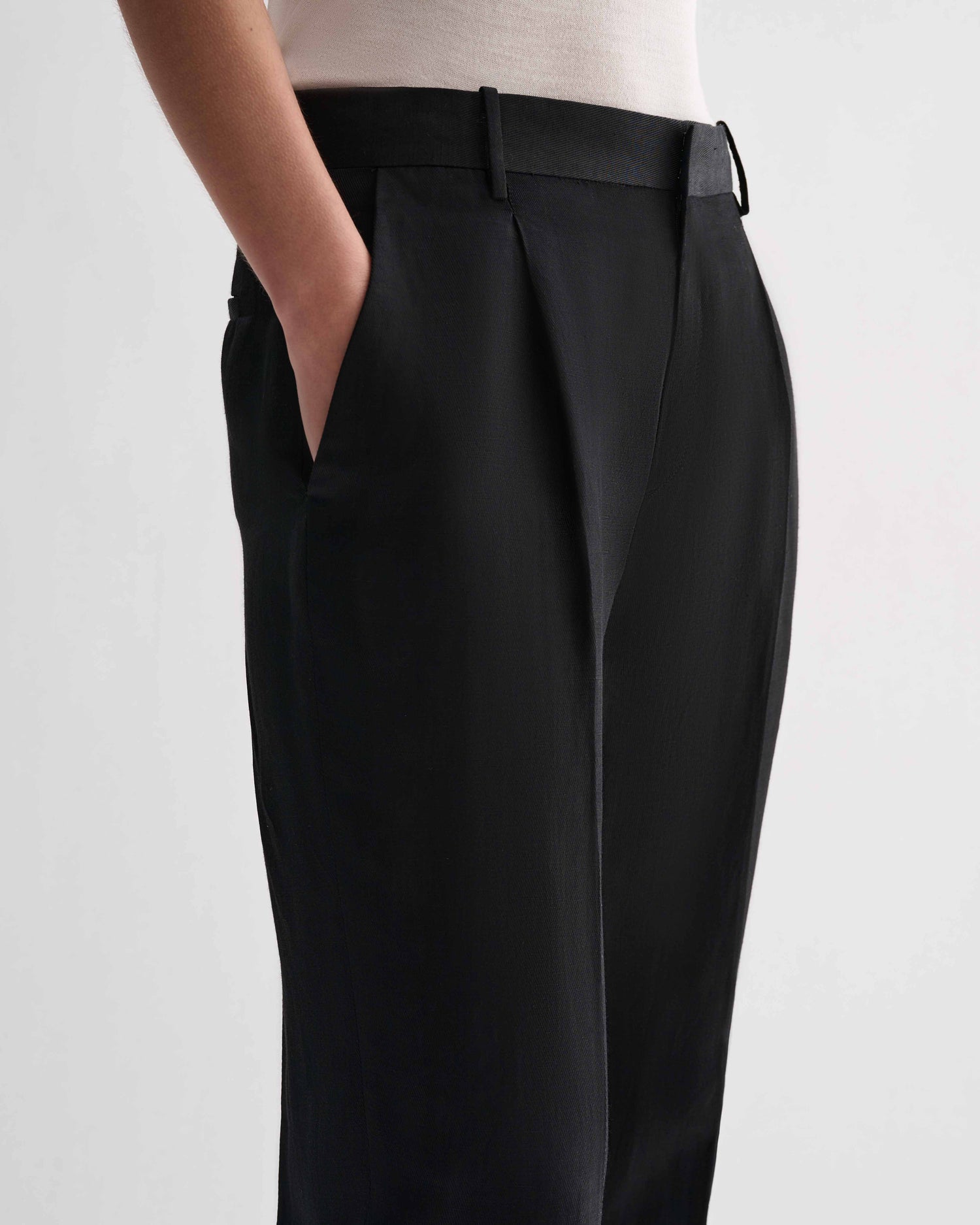 Black Billie Linen Trousers by Veronica De Piante, shown on a model, featuring a relaxed fit and tailored waistband.