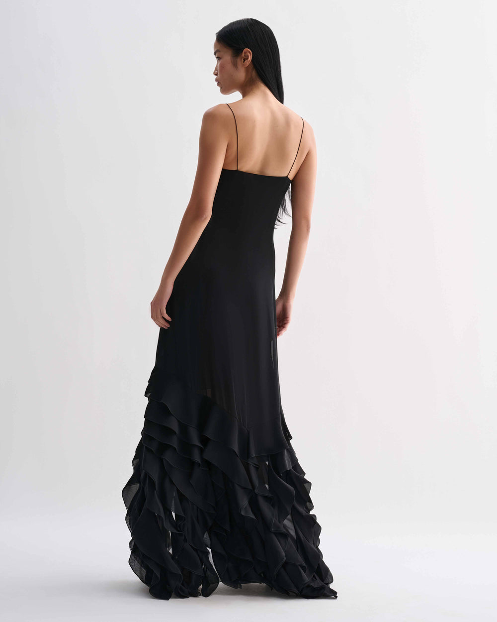Black Calista dress in georgette fabric by Veronica De Piante, featuring a flowing silhouette and elegant design.