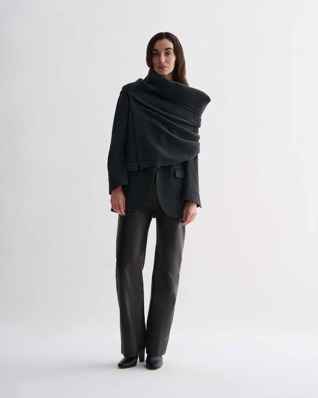 Charcoal wool cashmere Caro Snood knitwear on model. Dense gauge knitted shawl, generously draped over shoulders.