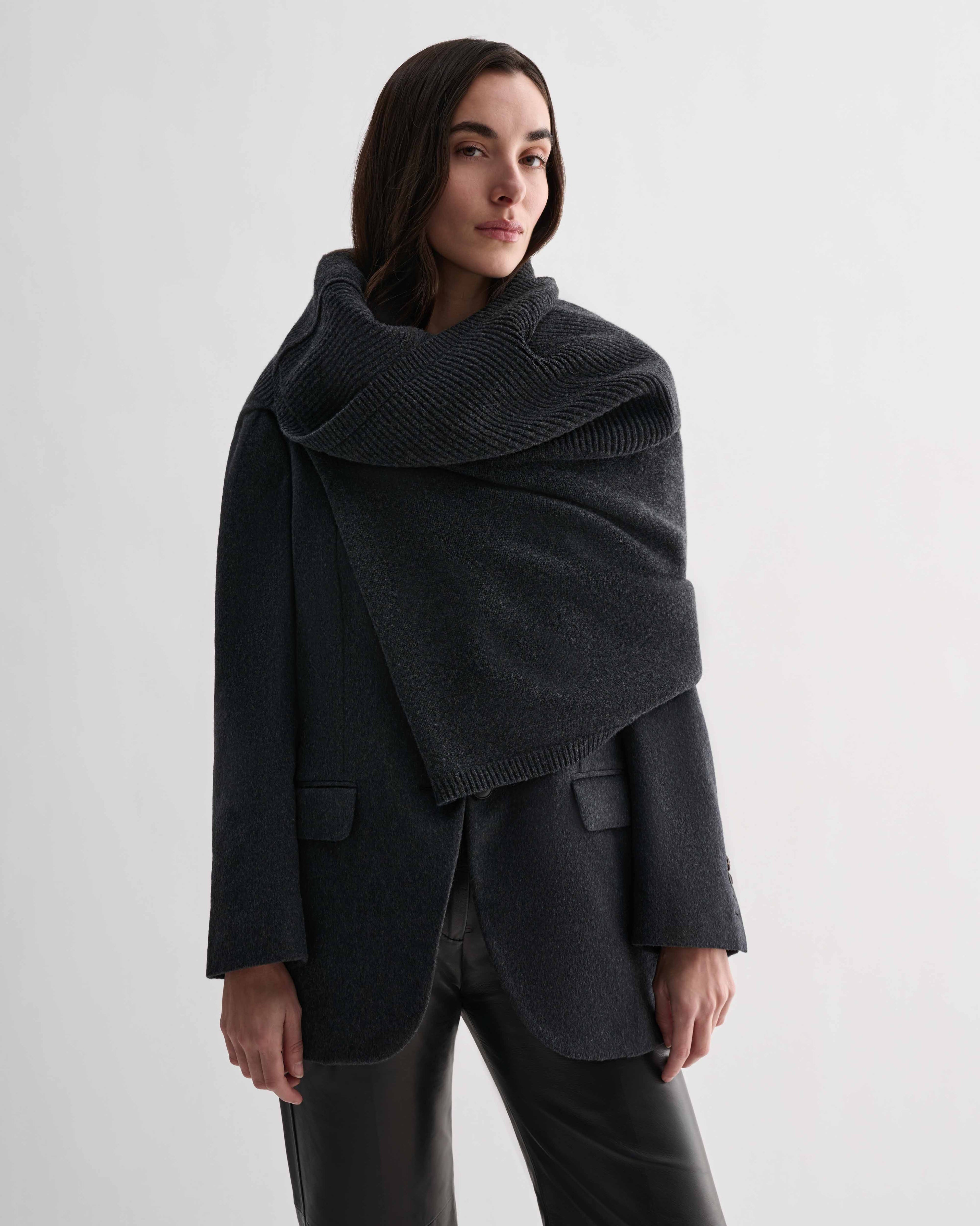 Caro Snood in charcoal wool cashmere knitwear on model. Dense gauge shawl wrapped at neck, settling on shoulders