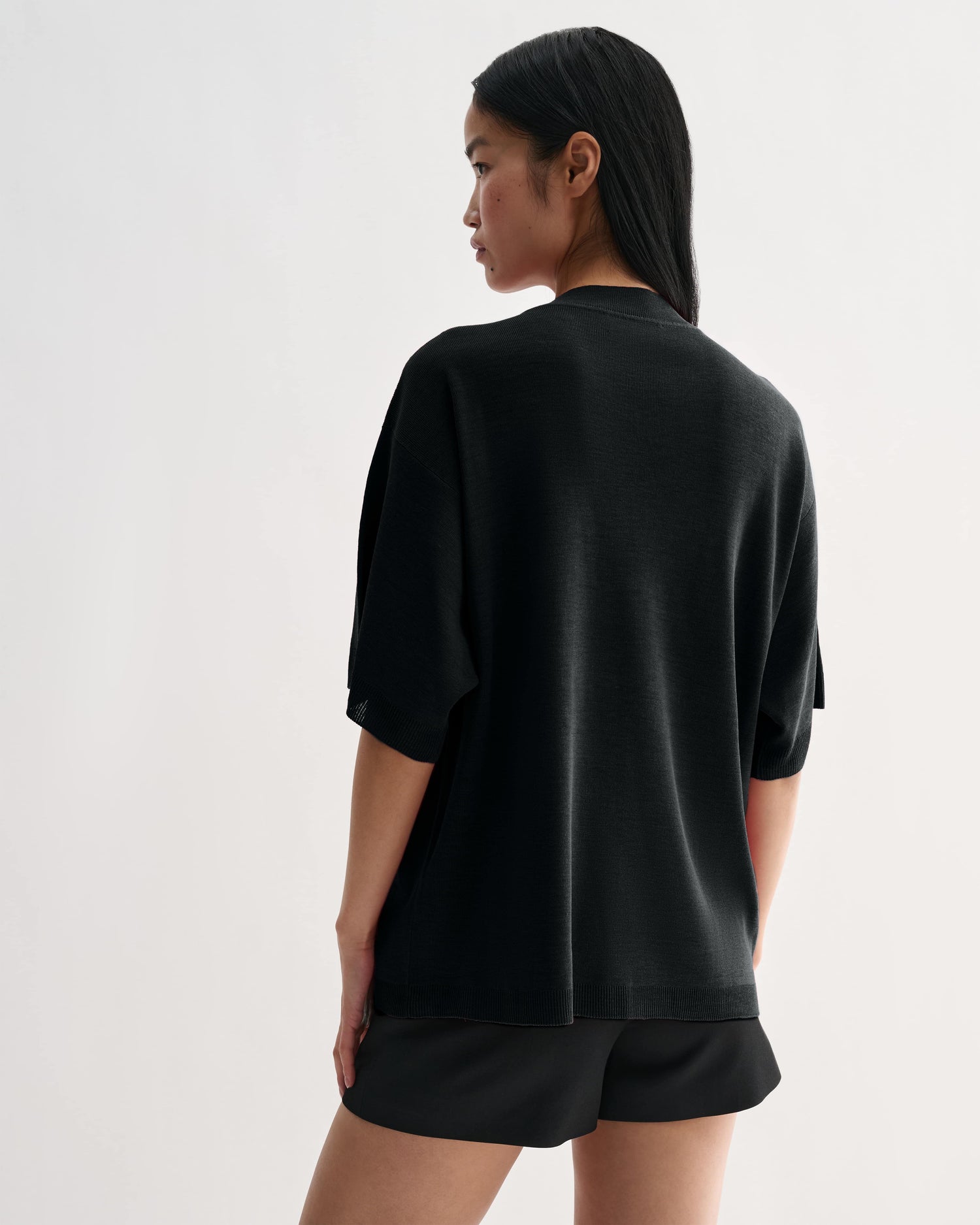 Black Carys knit top by Veronica De Piante, featuring a fitted Viscose fabric design with long sleeves and a stylish neckline.
