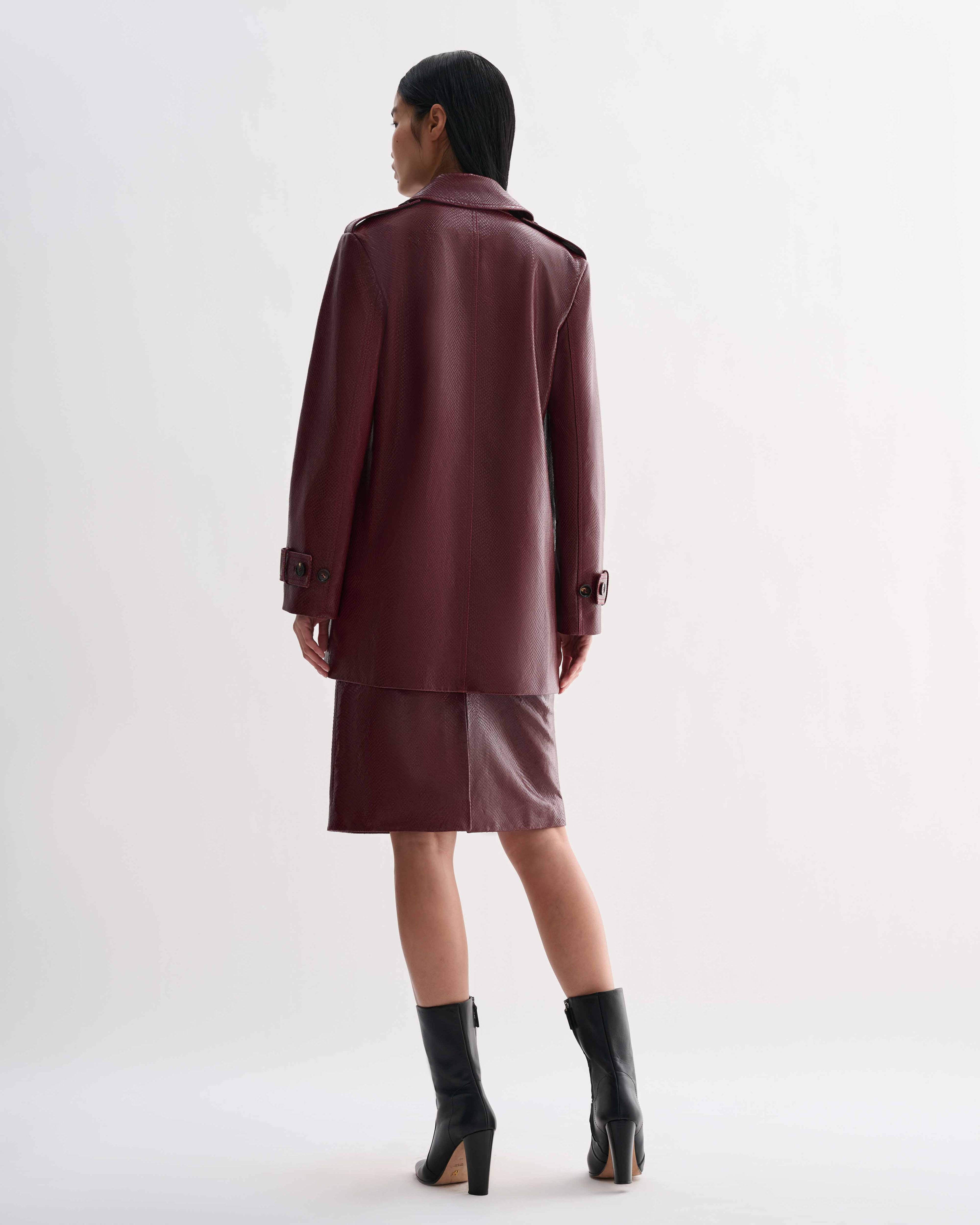 Dark red Charlotte Trench embossed leather trench coat, snakeskin pattern, worn by model from back