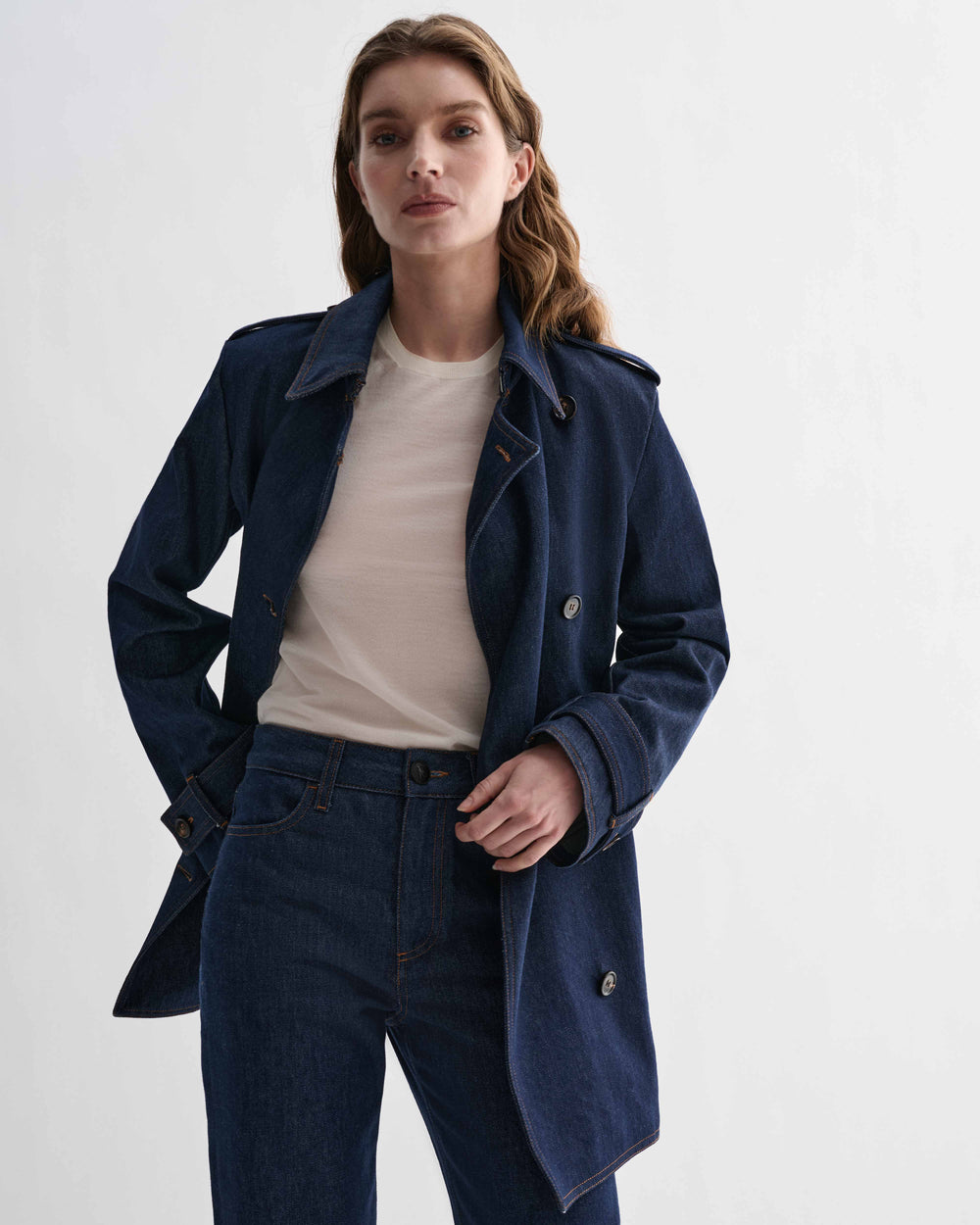 Blue Charlotte Trench coat in denim by Veronica De Piante, displayed on a hanger against a neutral background.