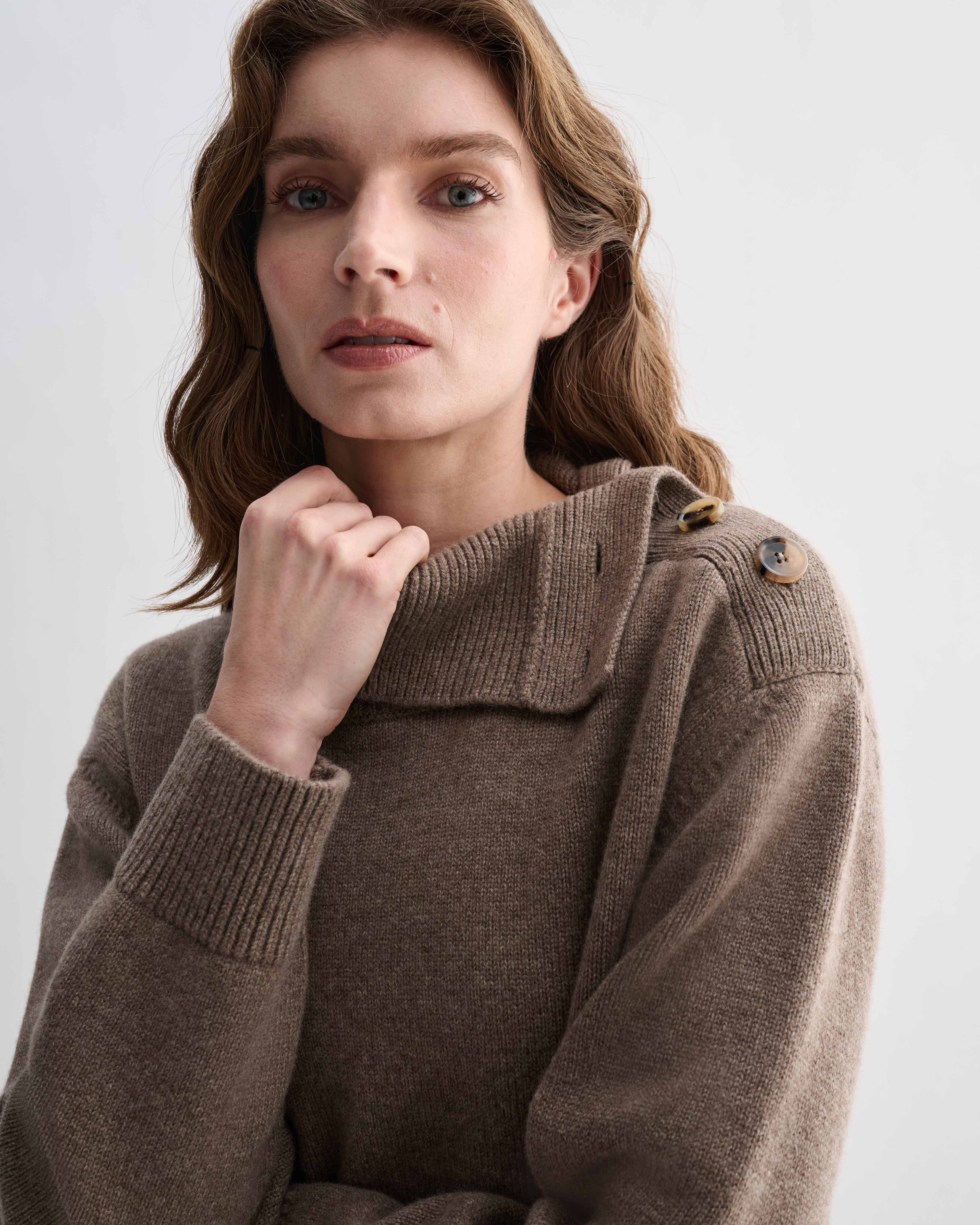 Model wearing Cielo Camel Wool Cashmere chunky knit sweater. Features side horn buttons and adjustable neckline, relaxed fit