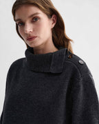 Cielo charcoal wool cashmere chunky knit sweater on model. Visible adjustable side buttoning neckline with dark horn buttons