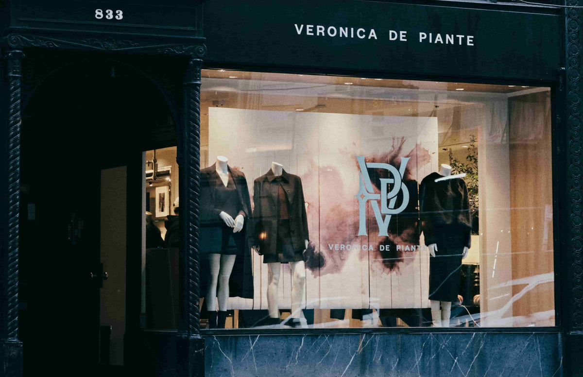 Veronica de Piante women's luxury fashion storefront. Mannequins display elegant dark coats, dresses, and premium apparel