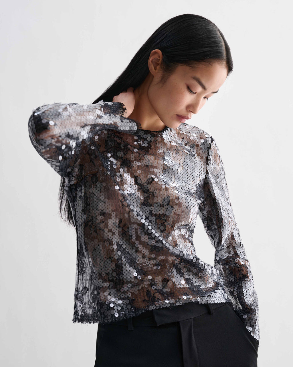 Dalia Top, black lace sequin long-sleeve crewneck. Dimensional shimmer, refined evening luxury top