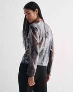 Black Dalia Top, crewneck, with shimmering dimensional lace sequins and long sleeves worn by a model