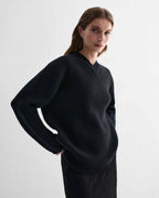 Elara Black Cashmere V-neck sweater on model. Elevated, dense knit, relaxed fit, eased shoulder luxury knitwear