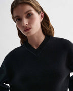 Elara black cashmere V-neck sweater on model. Elevated, dense knit, relaxed fit knitwear