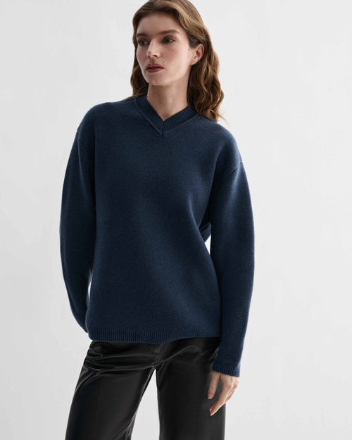 Elara blue cashmere V-neck sweater. Women's relaxed fit knit, dense and elevated knitwear on model.