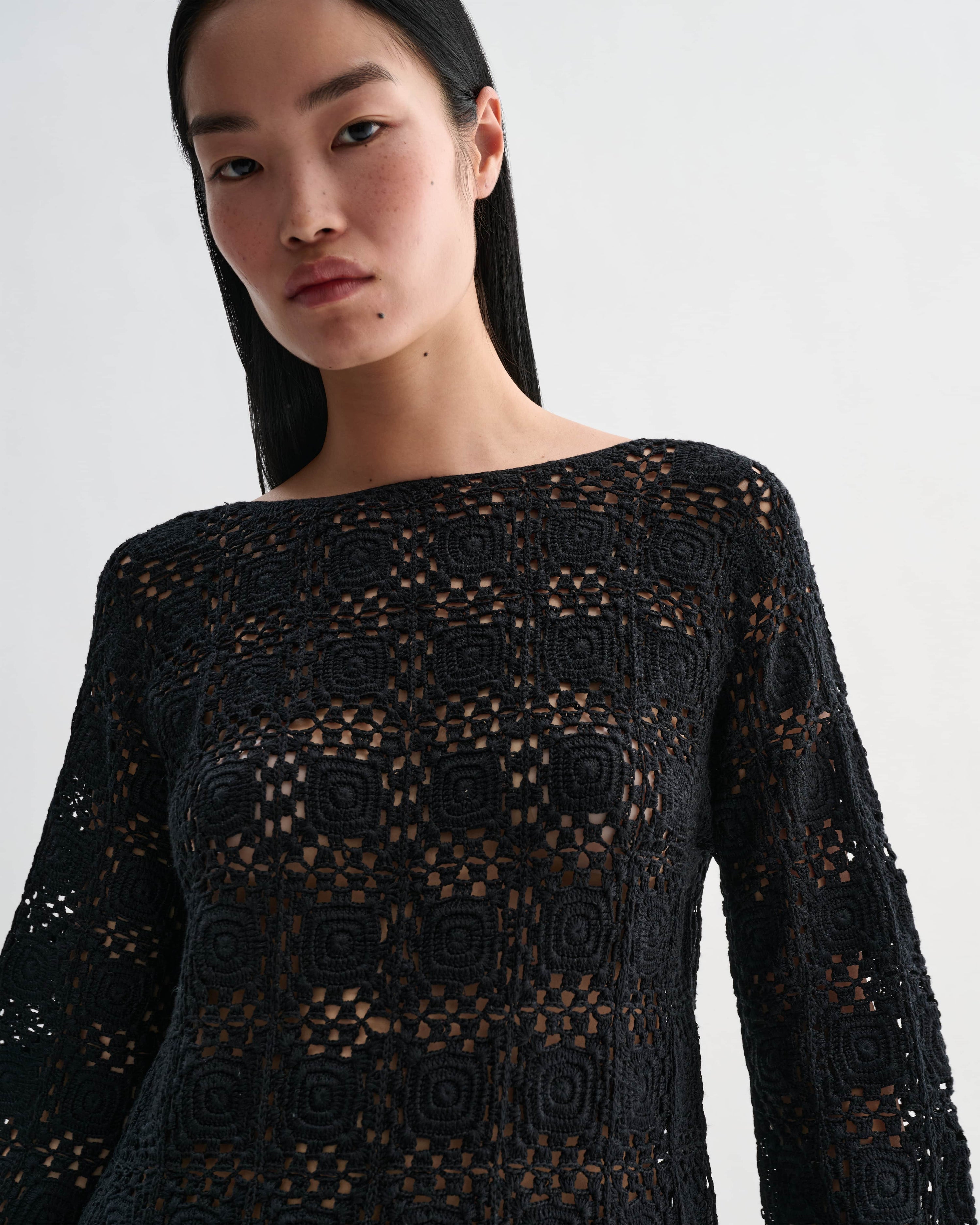 Black silk crochet Elodie top by Veronica De Piante, showcasing intricate knitwear with detailed crochet pattern.