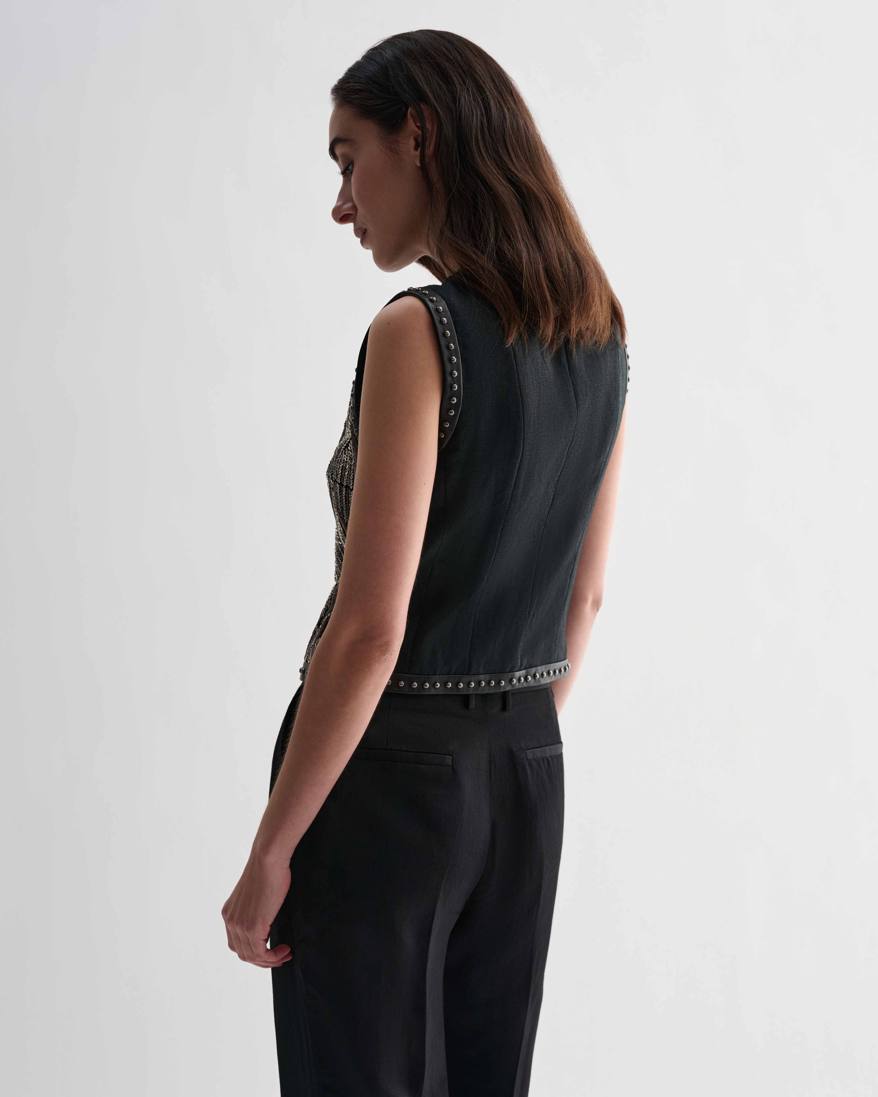 Black Ginevra vest by Veronica De Piante, stylish sleeveless top with a fitted design, shown on a model.