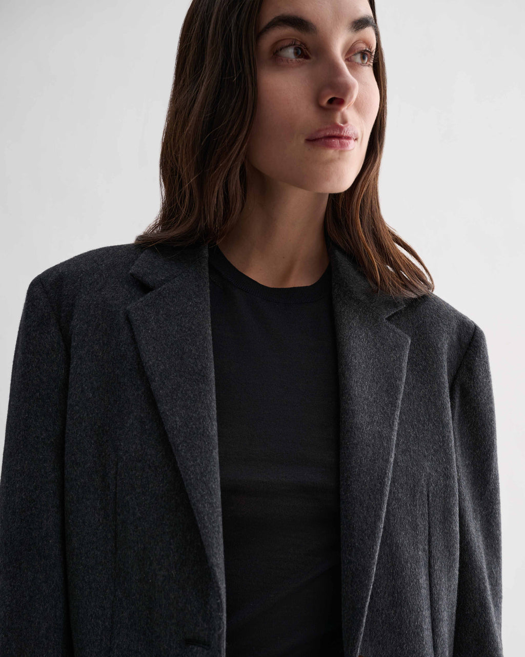 Model wears grey pure cashmere Gio blazer jacket with classic tailored lines. Women's luxury outerwear coat