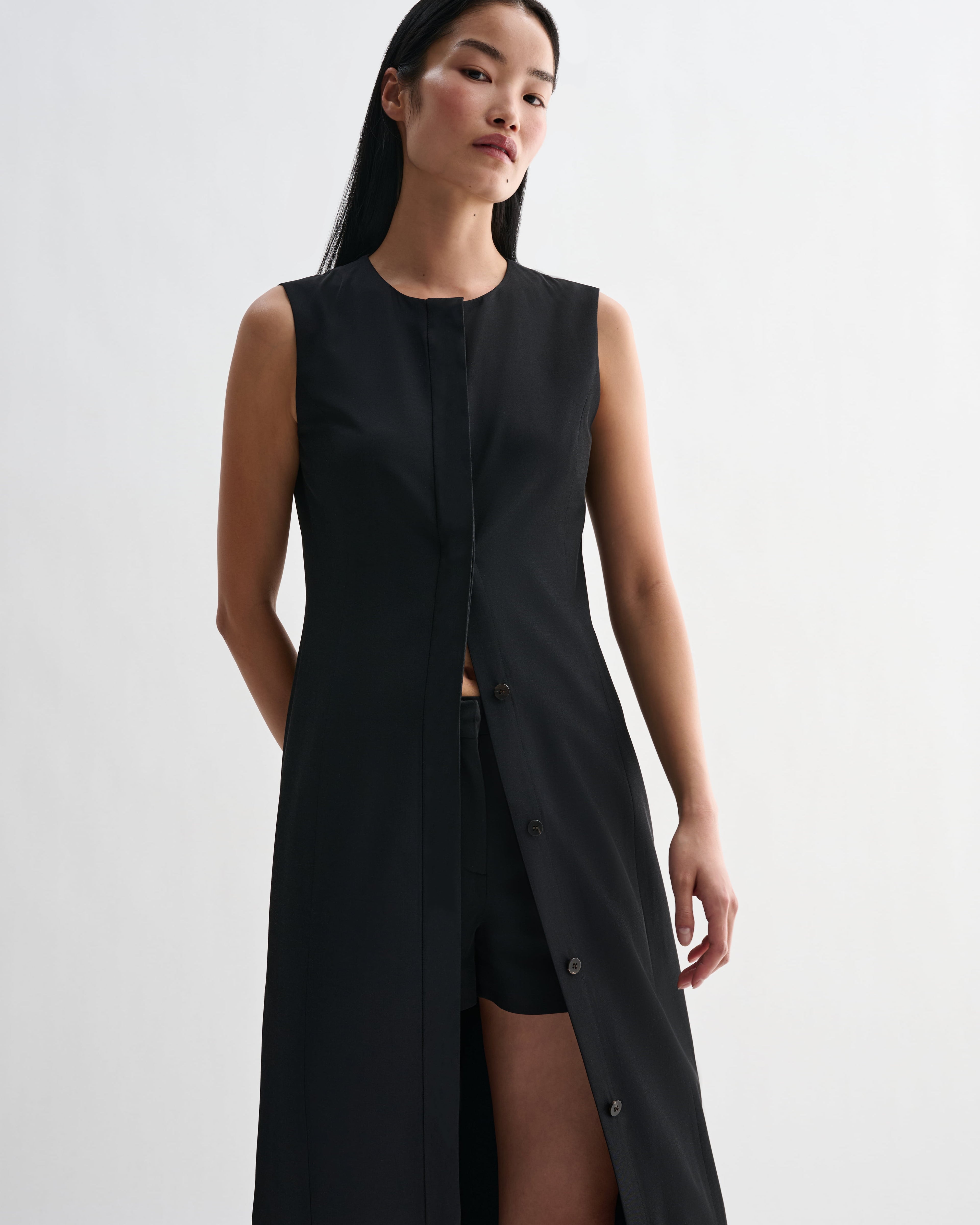 Black silk Hana Dress by Veronica De Piante, showcasing smooth fabric and elegant design in a close-up image.