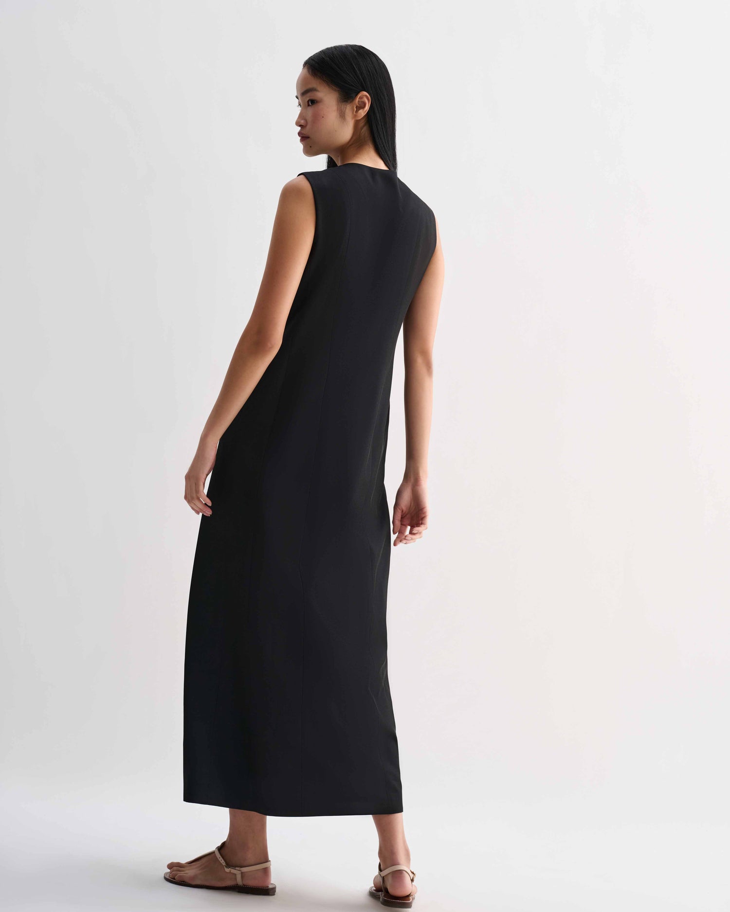 Black silk Hana dress by Veronica De Piante, showcasing elegant draping and a sleek, sophisticated design.