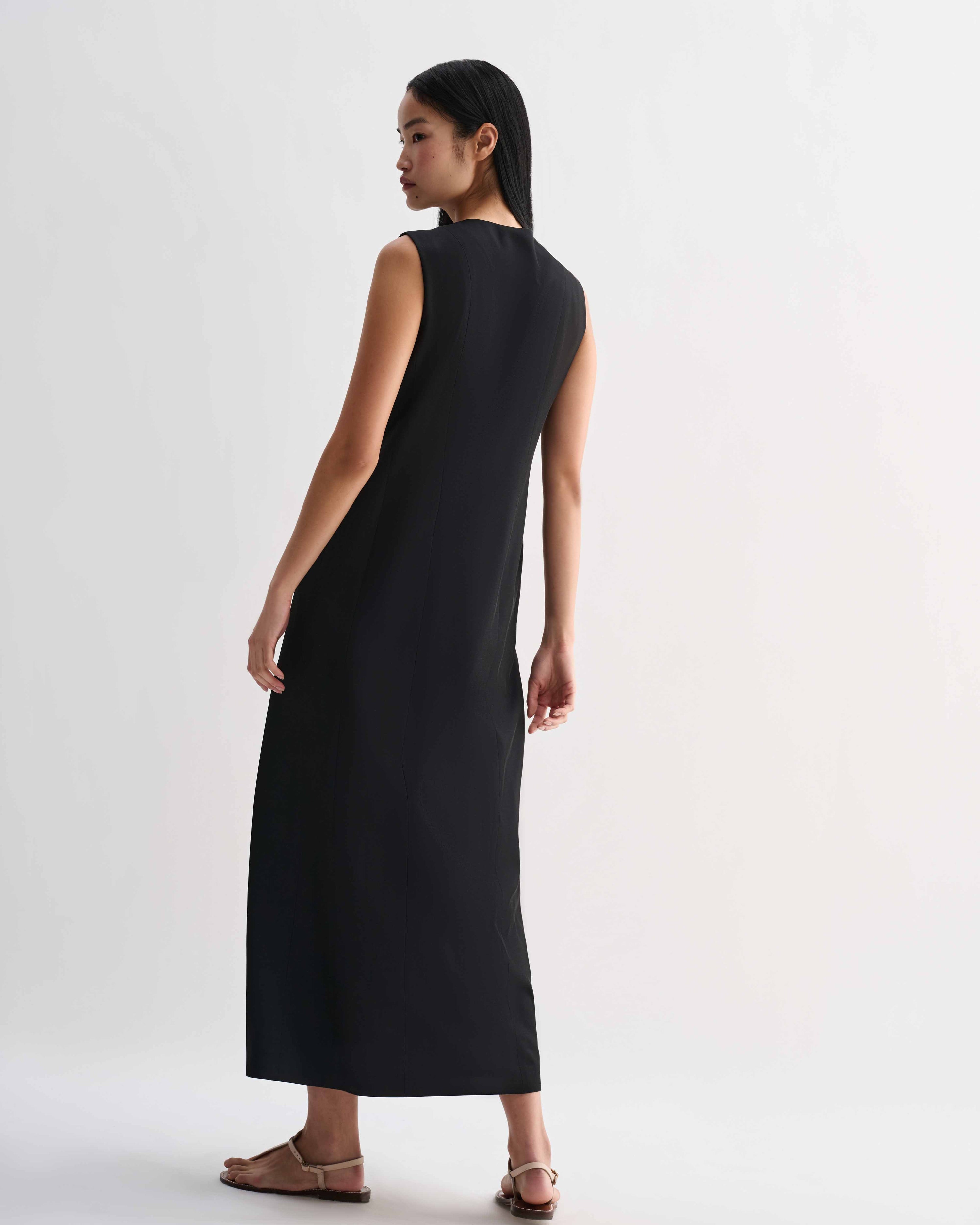 Black silk Hana dress by Veronica De Piante, showcasing elegant draping and a sleek, sophisticated design.